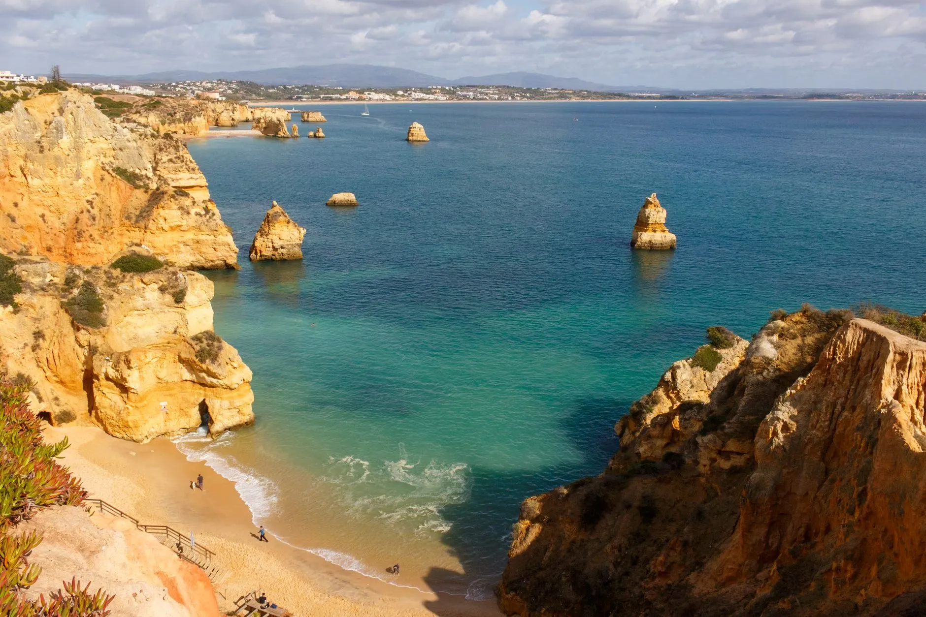 The Algarve, Portugal — Beautiful aerial view of Praia do Camilo, Lagos, with golden cliffs and turquoise waters in Algarve, Portugal.