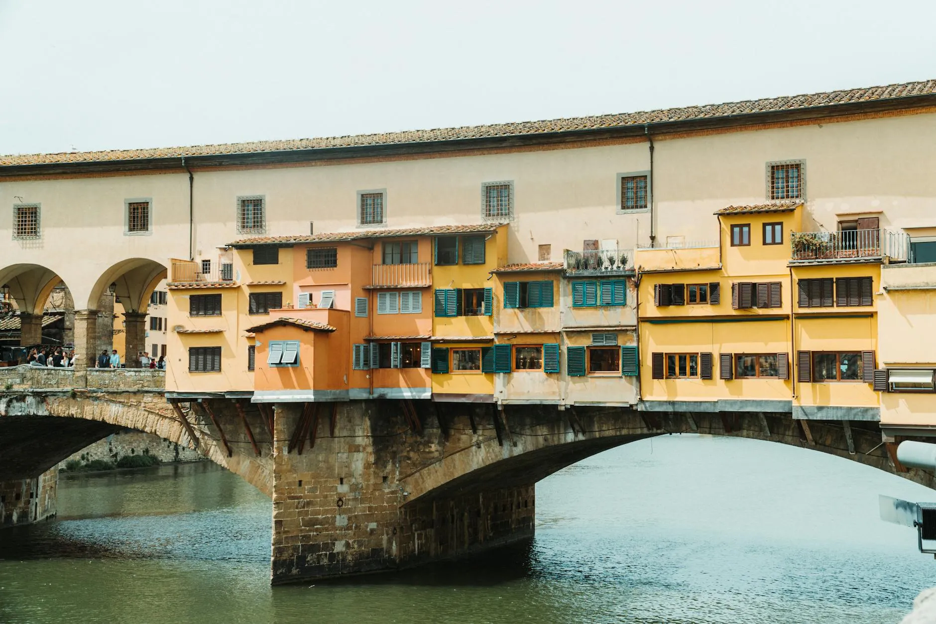 Florence, Italy — The iconic Ponte Vecchio bridge spanning the Arno River in Florence, Italy.