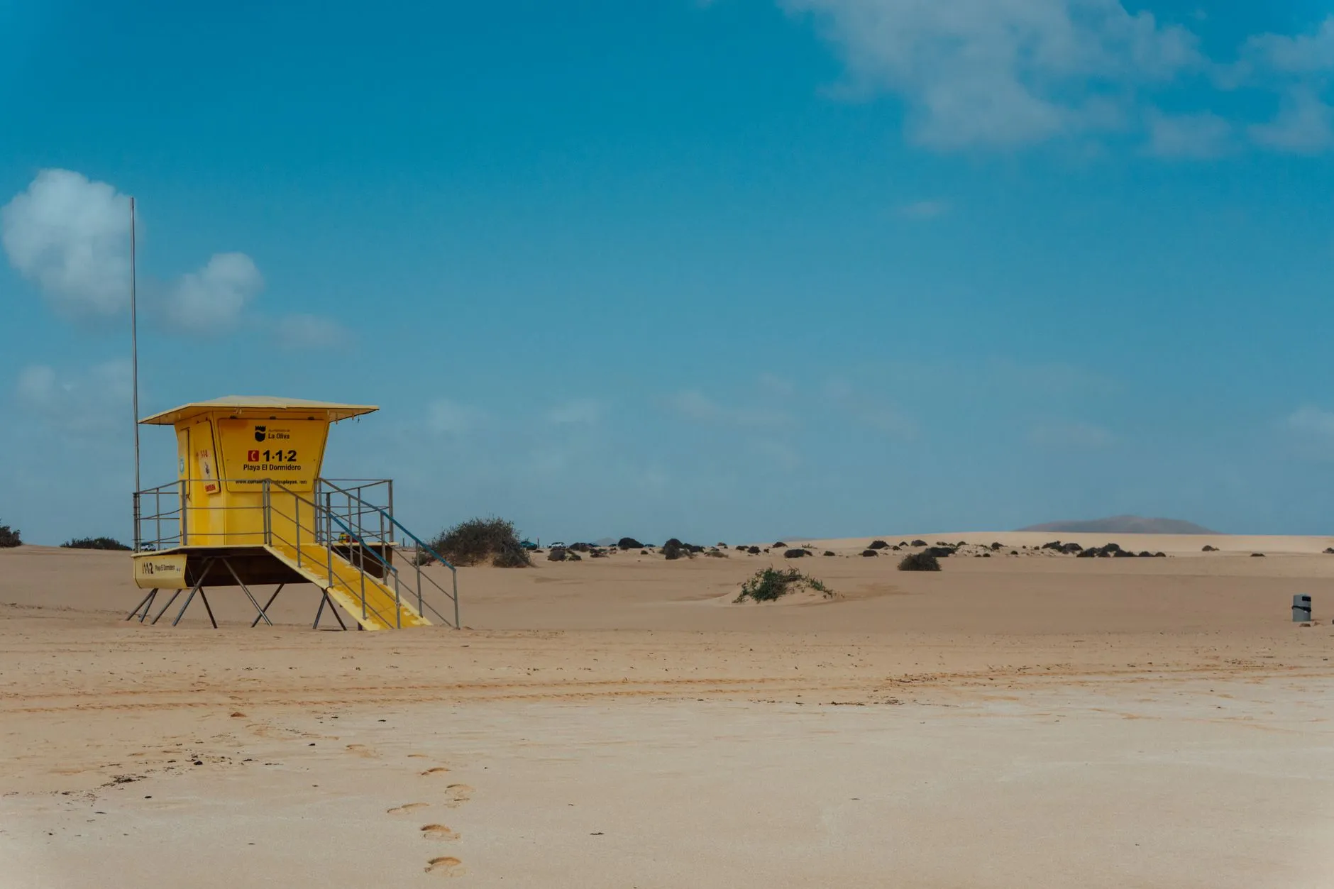 Fuerteventura, Canary Islands — A yellow lifeguard tower stands solitary on the sandy dunes of Fuerteventura, Canary Islands, Spain.