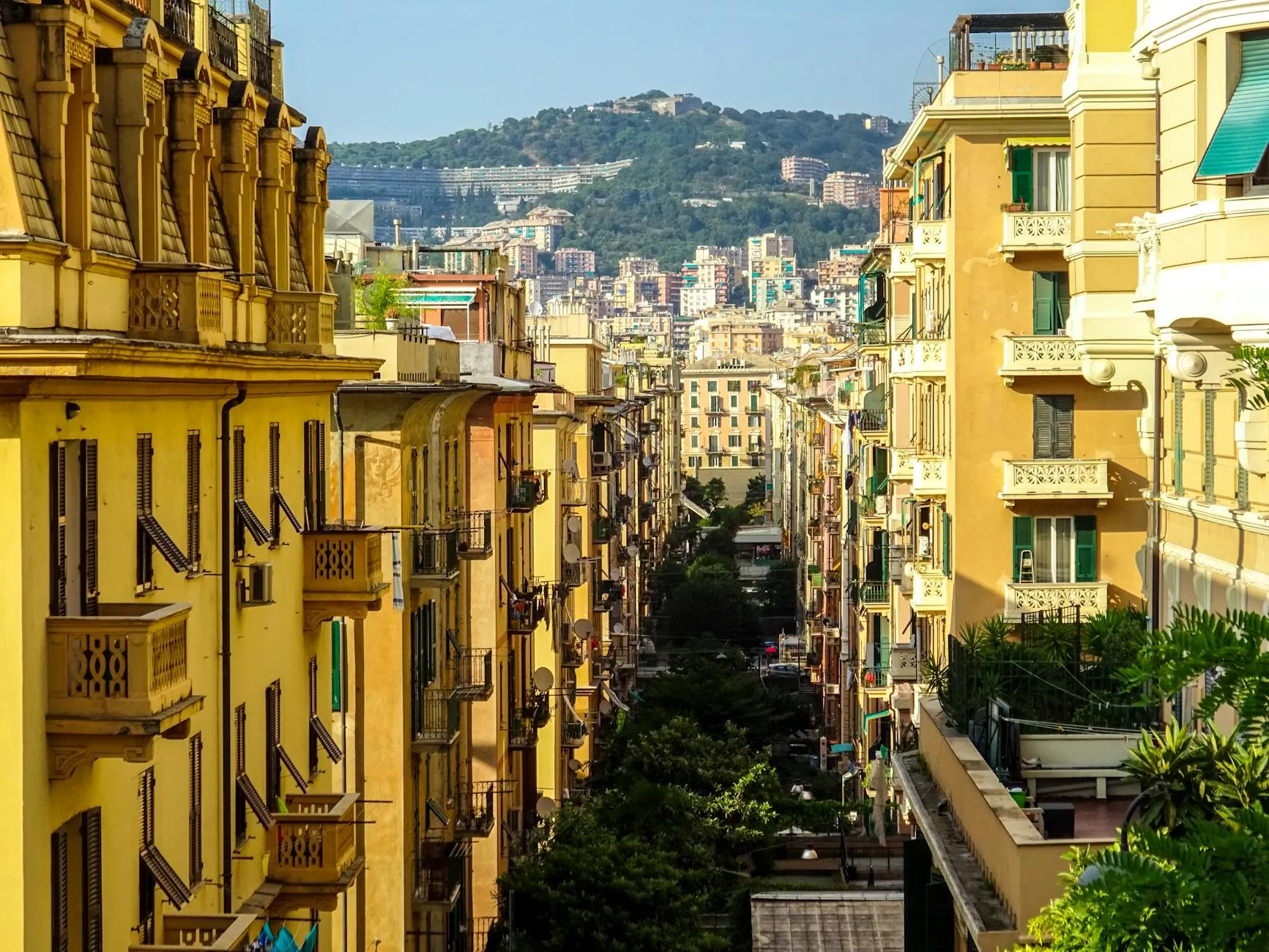Genoa, Italy — A vibrant street view in Genova, Liguria showcasing architectural details and lush greenery.