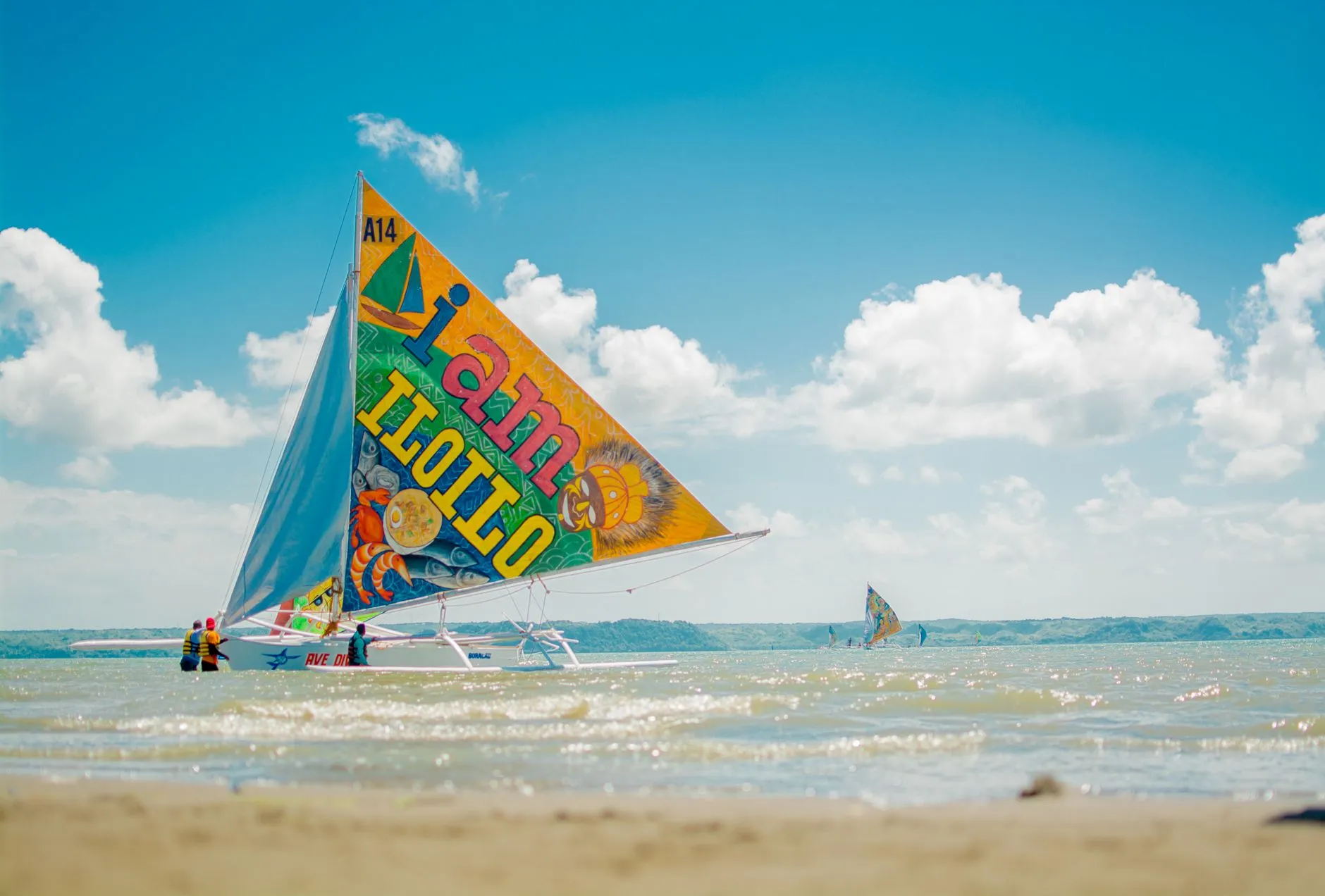 Iloilo, Philippines — Colorful sailboat on the beach in Iloilo City, Philippines under clear skies.