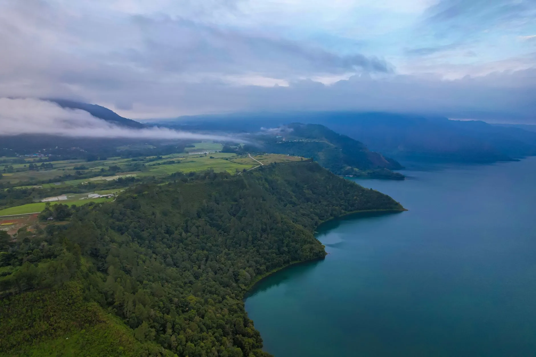 North Sumatra, Indonesia — Scenic aerial view of Lake Toba's lush green coastline in North Sumatra, Indonesia.