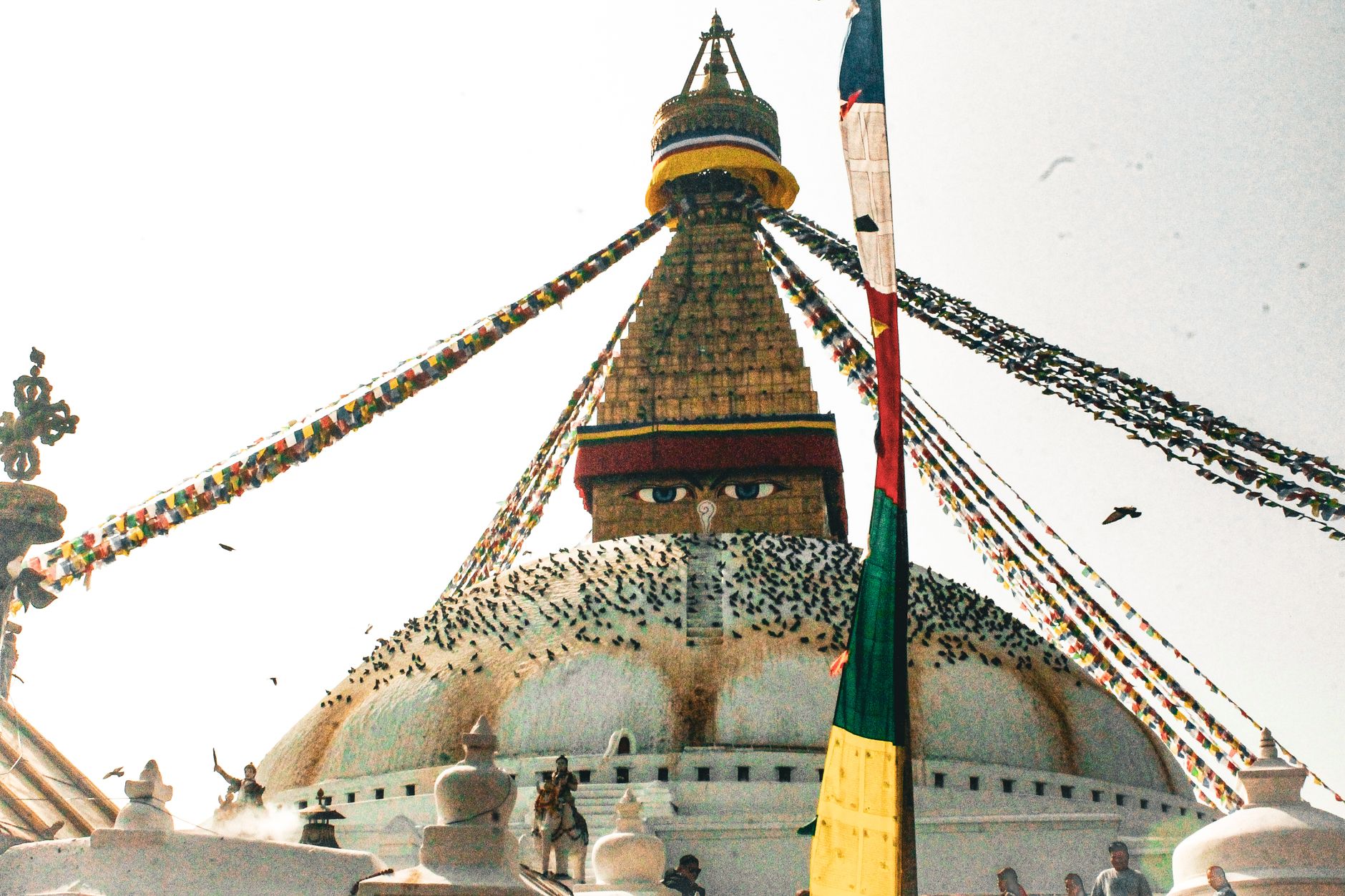 Nepal — Boudhanath Stupa with colorful prayer flags under clear sky in Kathmandu, Nepal.