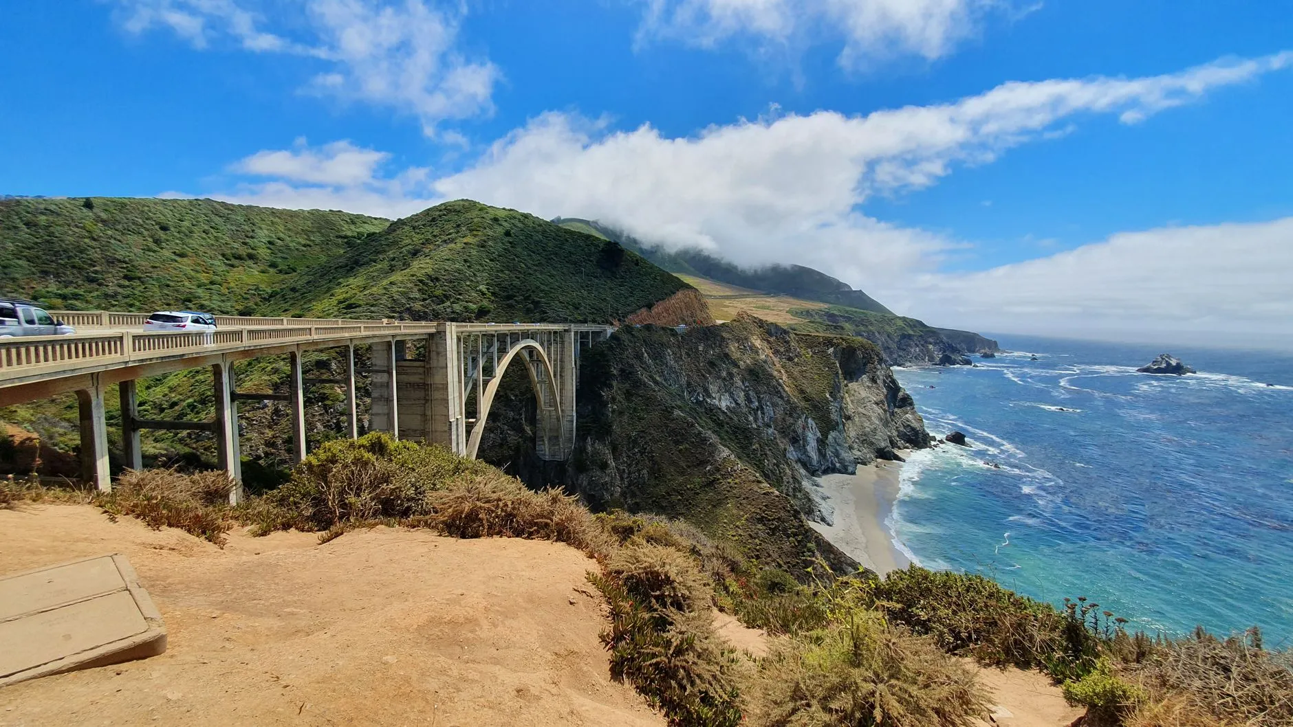 California — Stunning view of Bixby Creek Bridge against coastal cliffs and ocean in Big Sur, California.