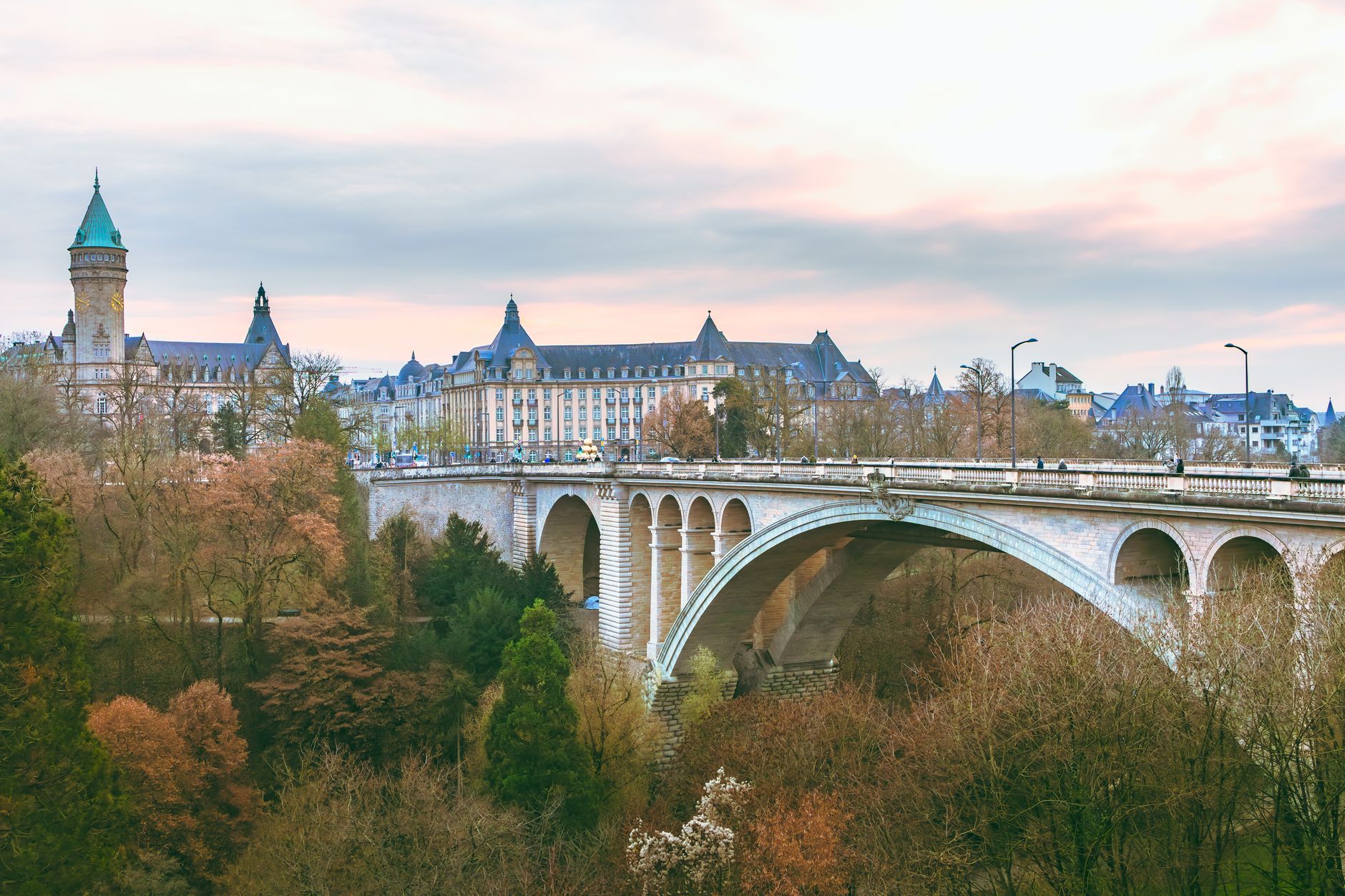 Luxembourg — Scenic view of the iconic Adolphe Bridge amidst fall foliage in Luxembourg City.