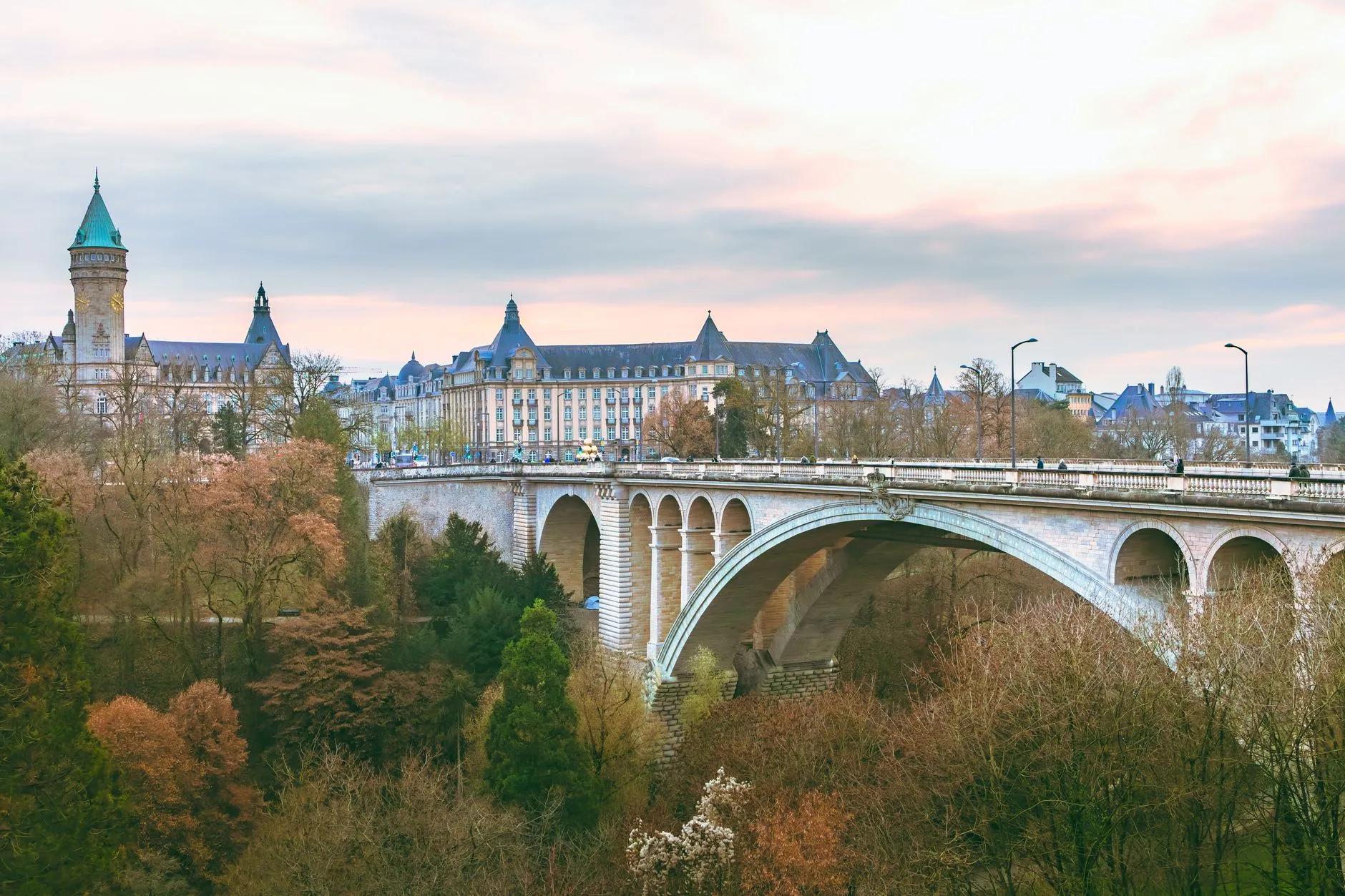 Luxembourg — Scenic view of the iconic Adolphe Bridge amidst fall foliage in Luxembourg City.