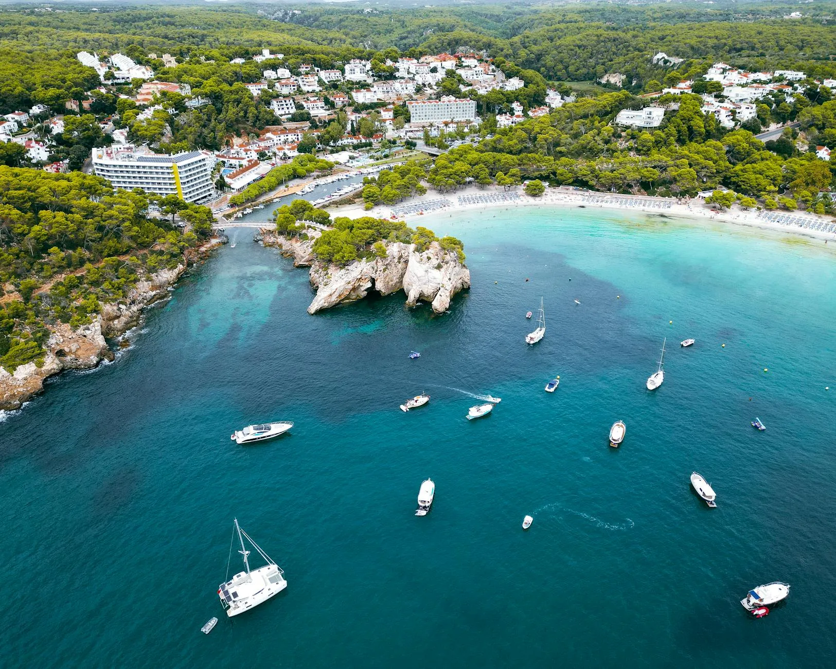 Menorca — Stunning aerial view of sailboats and clear blue waters at Cala Galdana, Menorca, Spain.