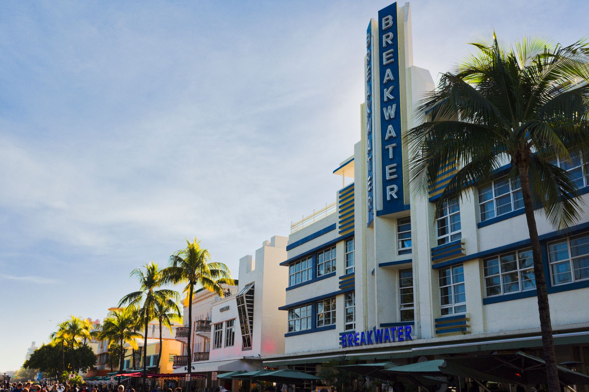 Florida — Art Deco Breakwater Hotel with palm trees in Miami Beach. Iconic South Beach architecture under a clear sky.