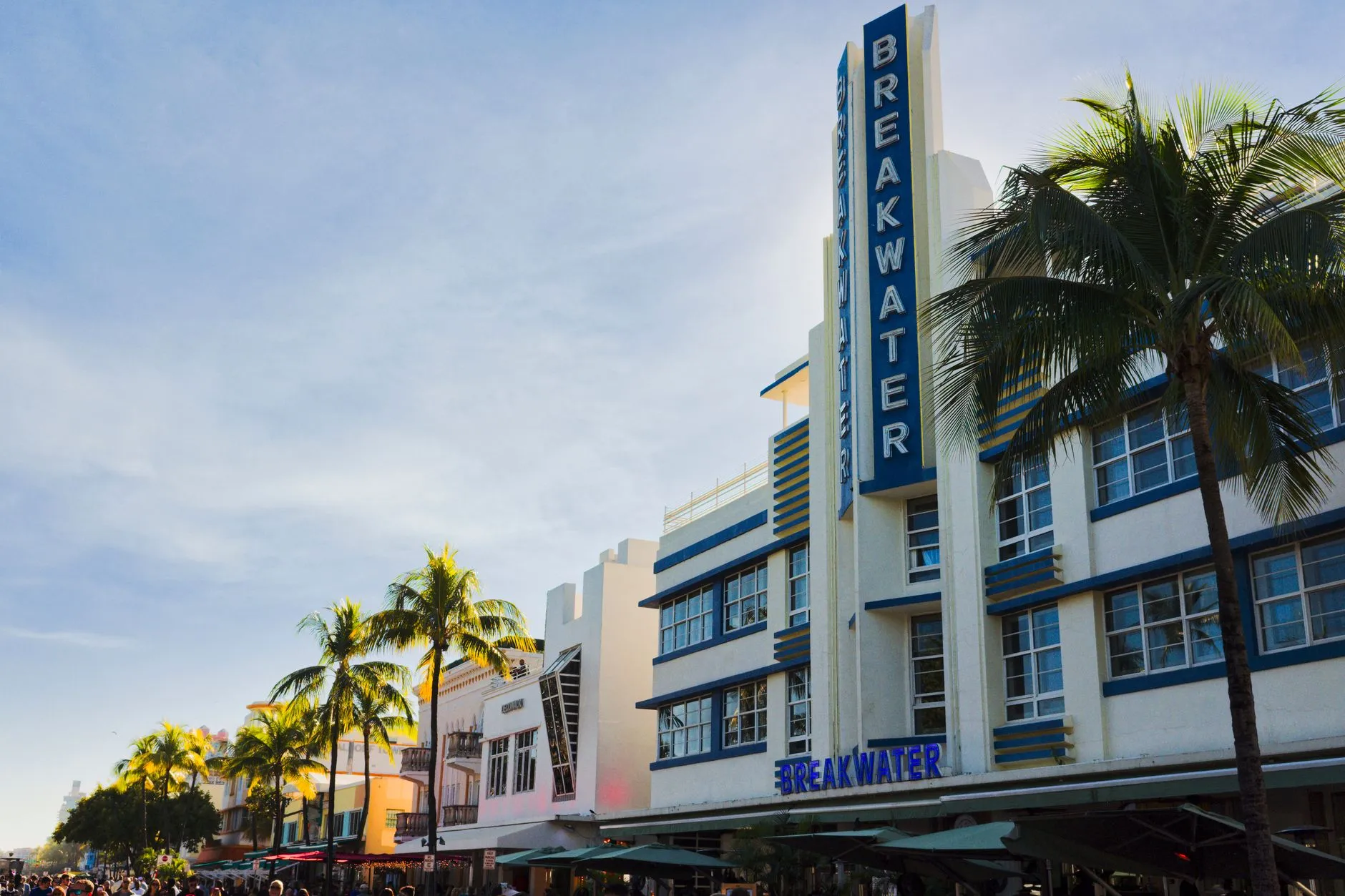 Florida — Art Deco Breakwater Hotel with palm trees in Miami Beach. Iconic South Beach architecture under a clear sky.