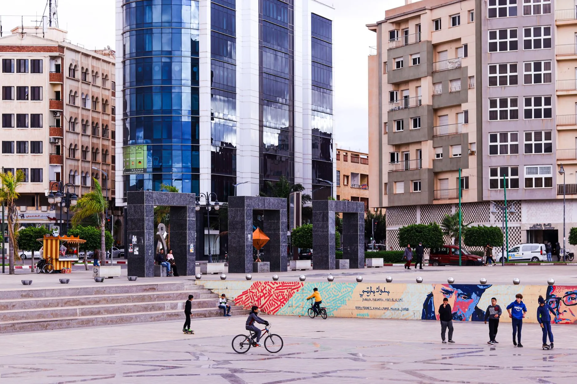 Oujda, Morocco — Children playing in a lively public square in Oujda, Morocco with modern buildings.