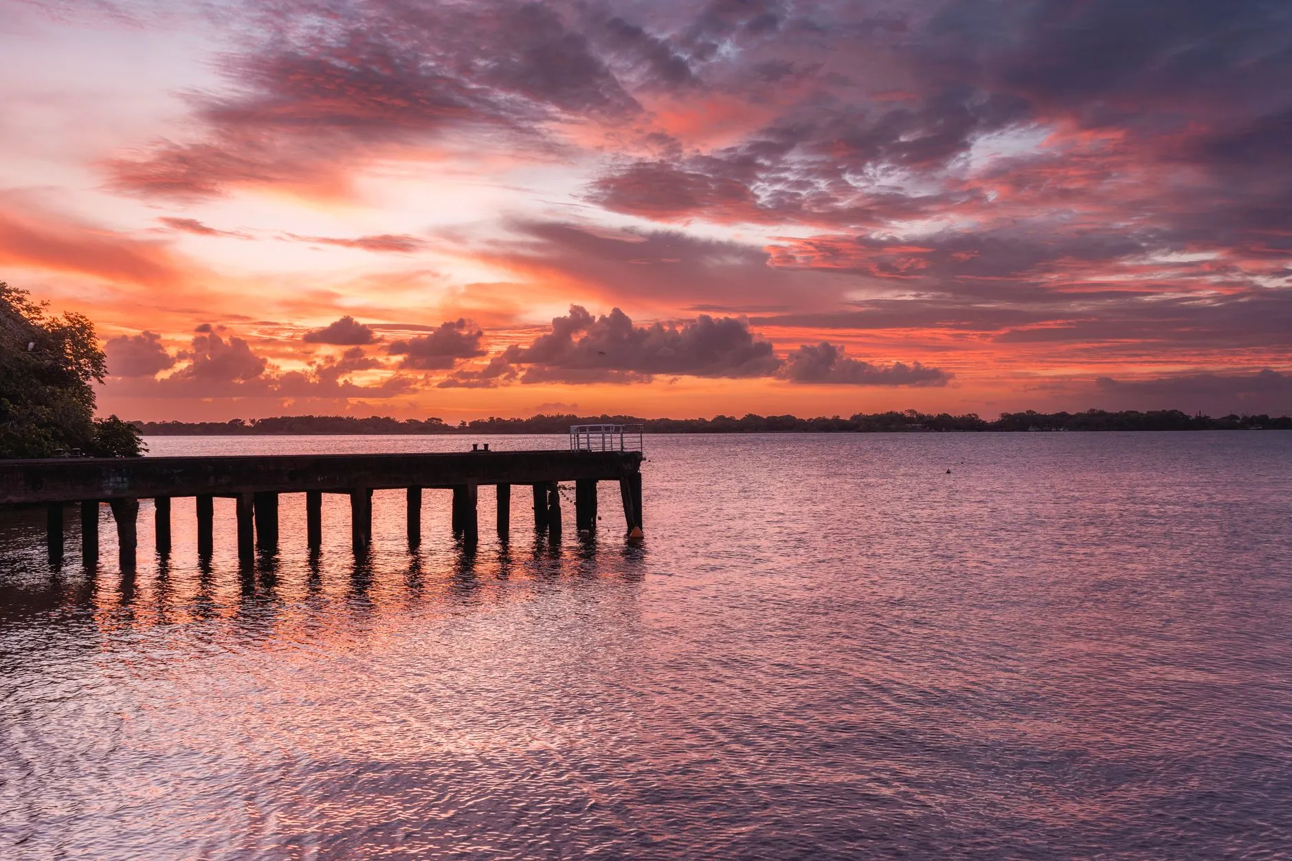 Porto Alegre, Brazil — A mesmerizing sunset view over a serene pier in Porto Alegre, Brazil.