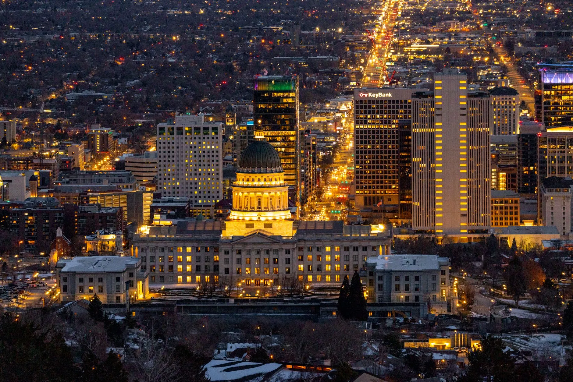 Salt Lake City, USA — Stunning aerial view of Salt Lake City skyline featuring the Utah State Capitol illuminated at night.