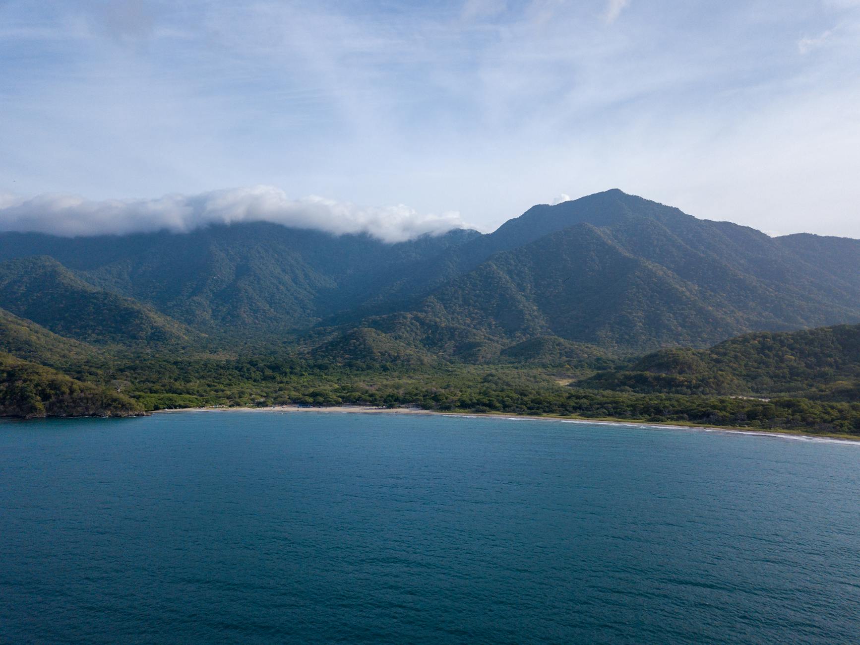 Santa Marta, Colombia — A breathtaking aerial view of the Sierra Nevada mountains meeting the Caribbean Sea in Magdalena, Colombia.