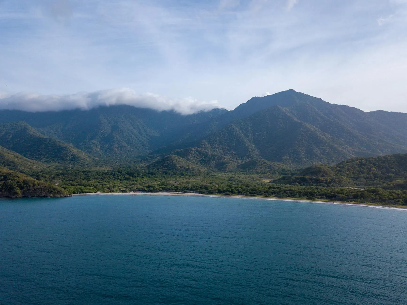 Santa Marta, Colombia — A breathtaking aerial view of the Sierra Nevada mountains meeting the Caribbean Sea in Magdalena, Colombia.