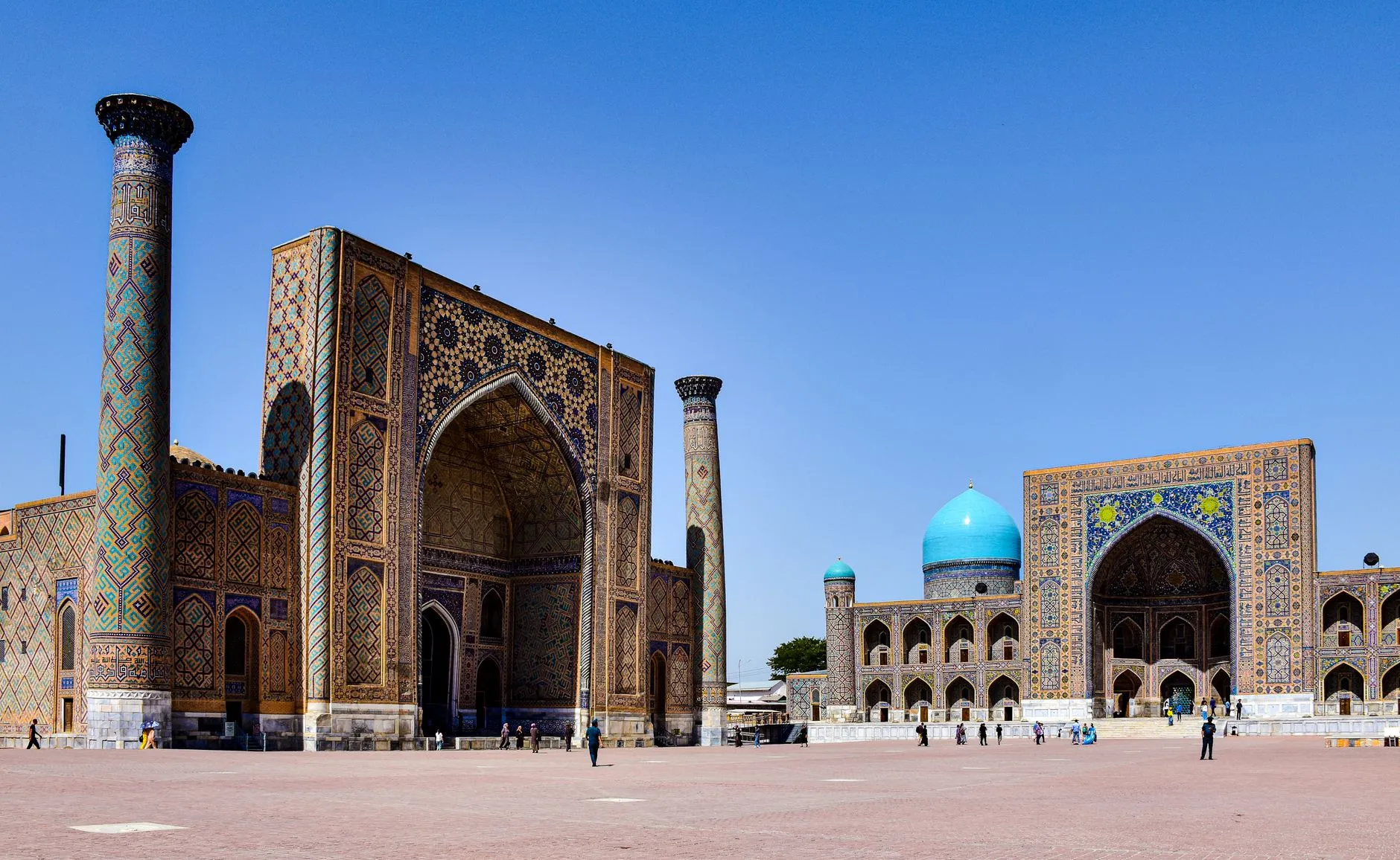 Uzbekistan — Explore the stunning architecture of Registan Square in Samarkand, Uzbekistan under a clear blue sky.