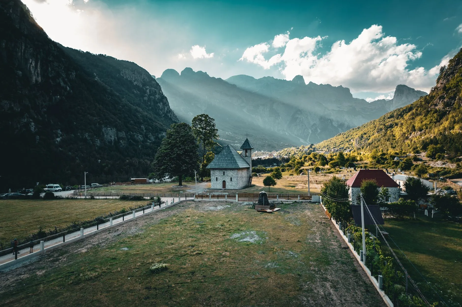 Albania — Scenic view of Theth village with mountains and historic church in Albania.
