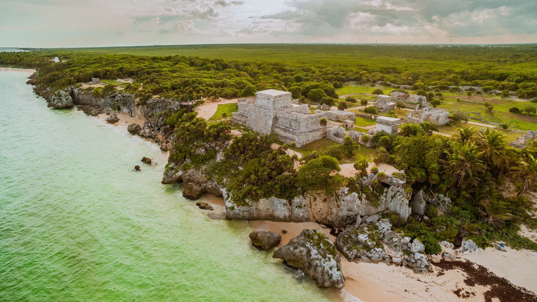 Tulum, Mexico — Stunning aerial view of the ancient Tulum Mayan ruins overlooking the turquoise Caribbean Sea in Mexico.