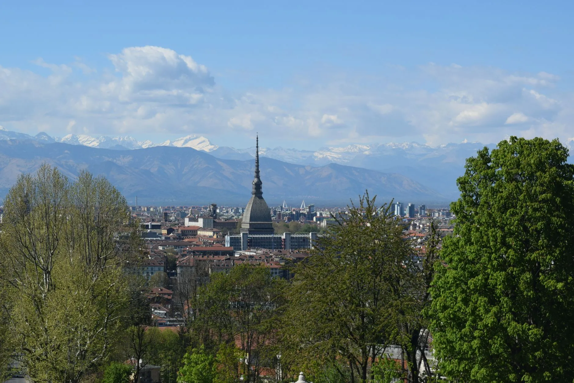Turin, Italy — Turin cityscape with Mole Antonelliana and Alps under blue skies, Piemonte, Italy.