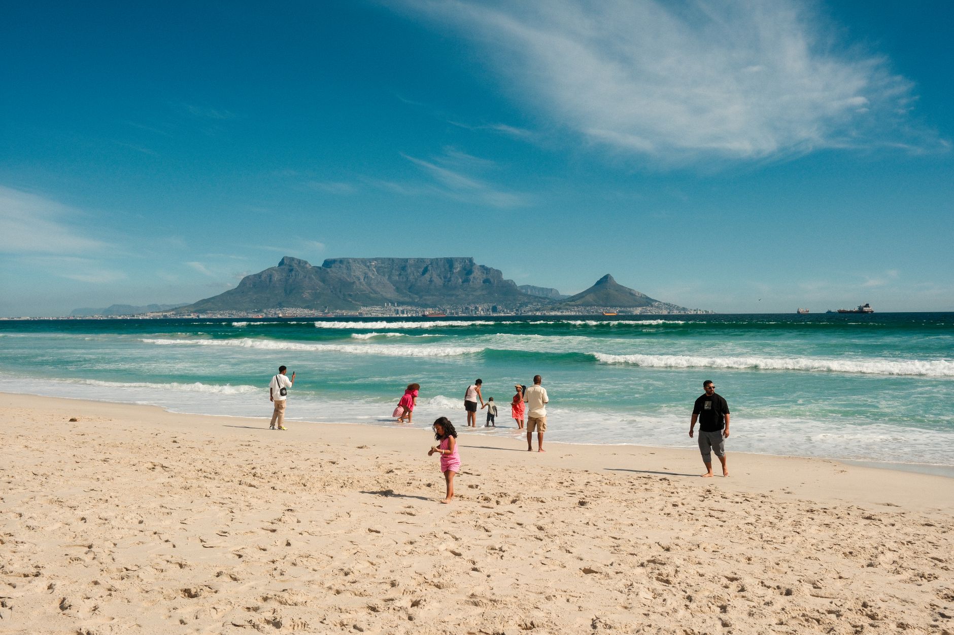 Cape Town, South Africa — Table Mountain across the bay from a white-sand beach