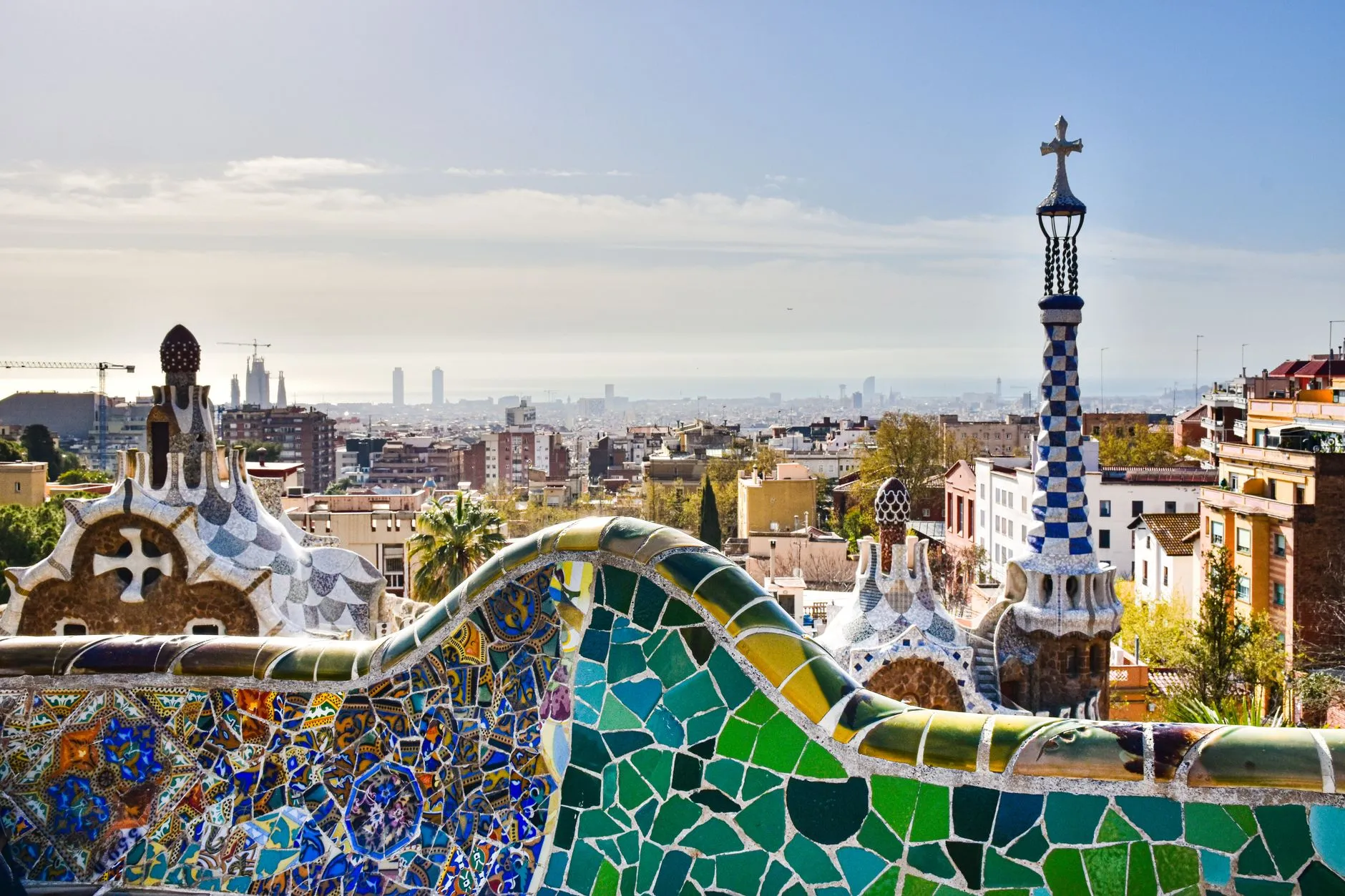Gaudi's mosaic terrace at Park Guell overlooking the Barcelona skyline and the Mediterranean on a clear day