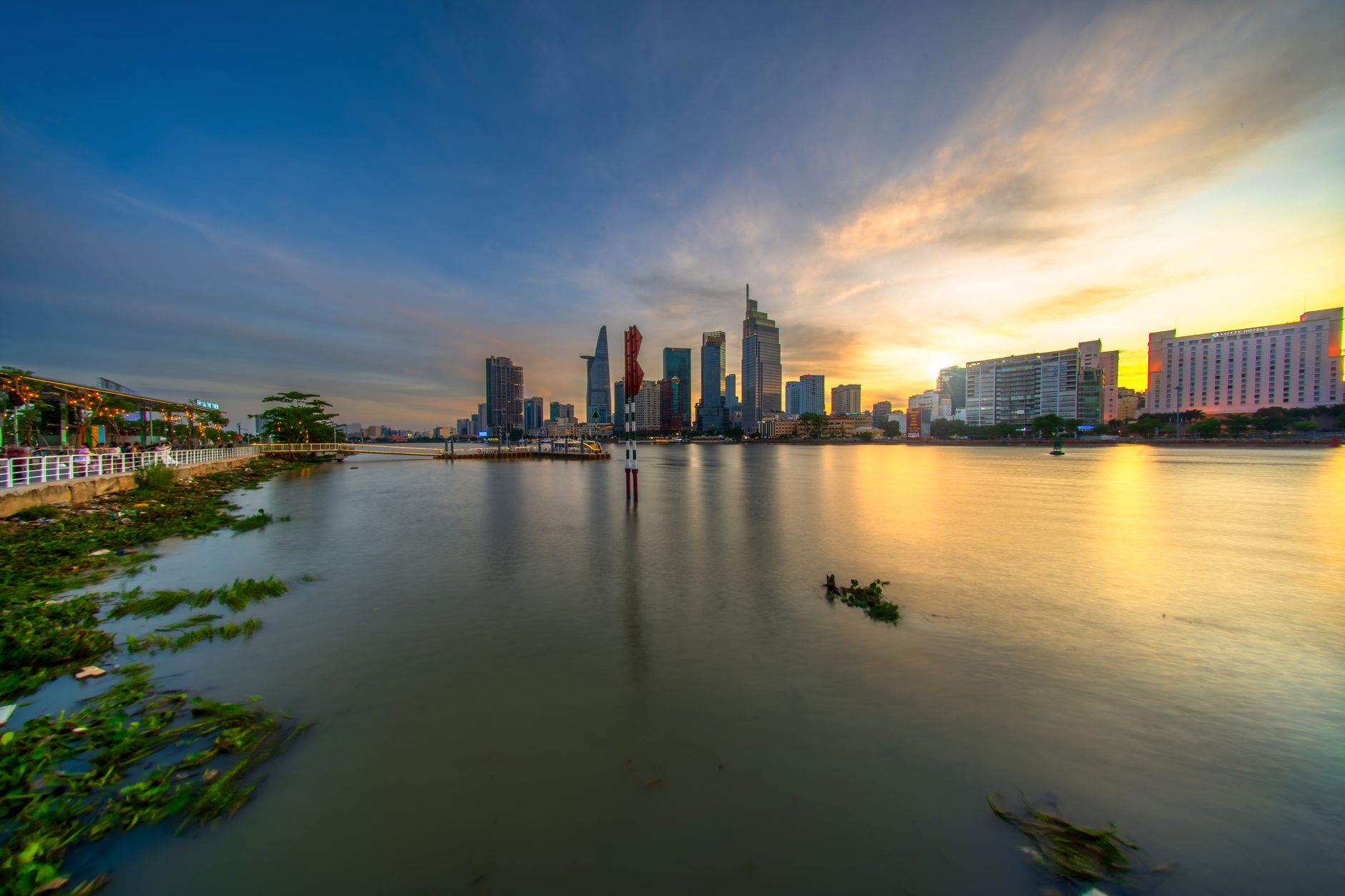 Beautiful sunset view of the Saigon River with Ho Chi Minh City skyline in Vietnam.