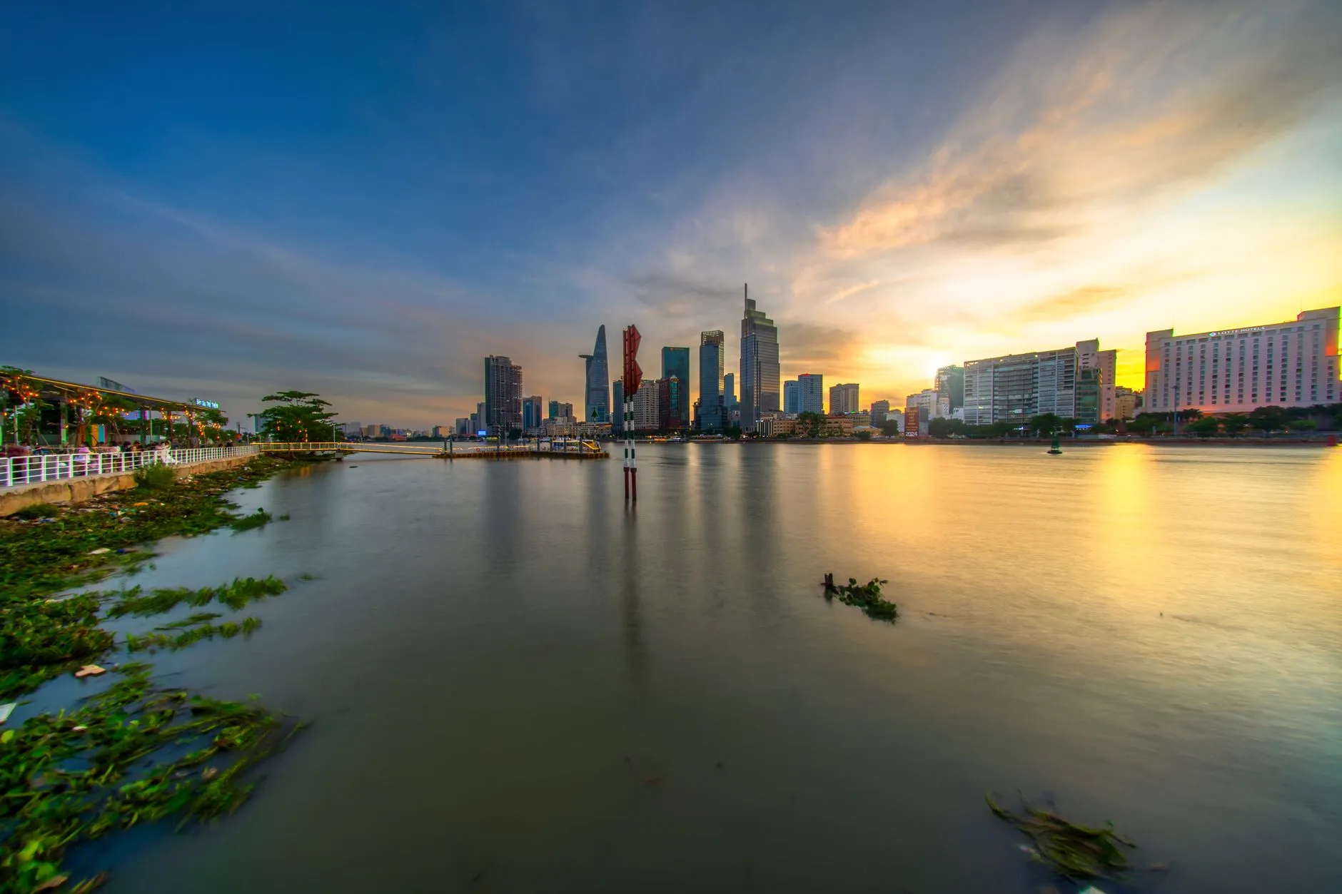 Beautiful sunset view of the Saigon River with Ho Chi Minh City skyline in Vietnam.