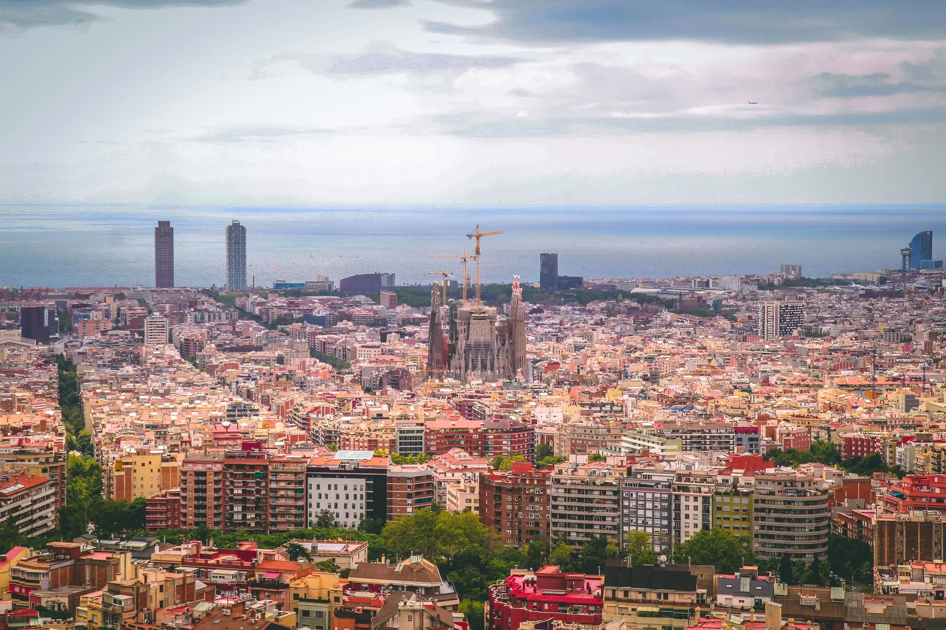 Barcelona — a panoramic view of Barcelona city with Sagrada Familia and coastline in daylight