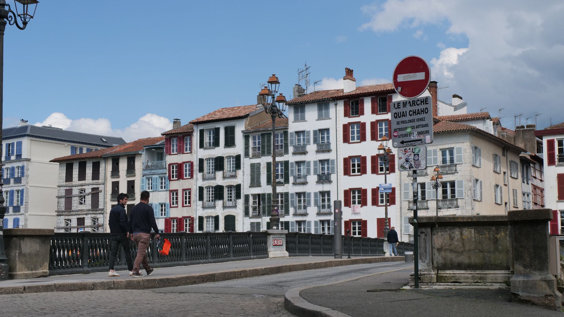 Biarritz, France — Charming street scene in Bayonne, France with traditional Basque architecture and pedestrians.