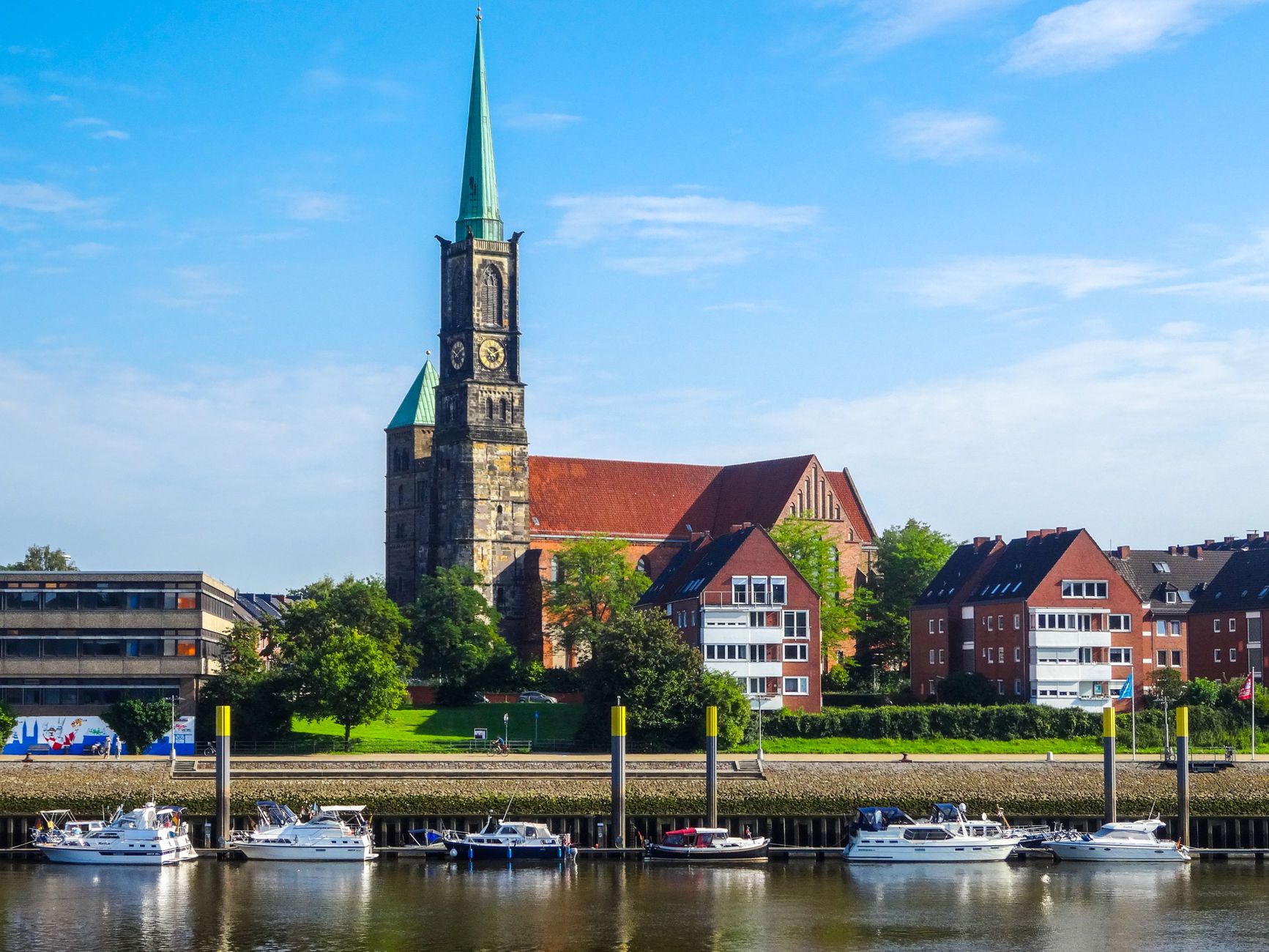 Bremen, Germany — View of St. Stephani Church and the scenic Weser River waterfront in Bremen, Germany.