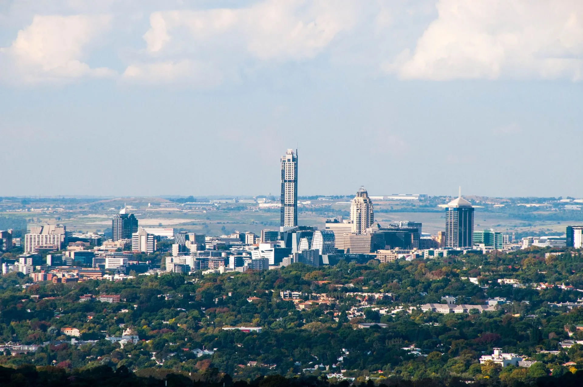 Aerial view of the Sandton skyline in Johannesburg, South Africa, under a clear sky.