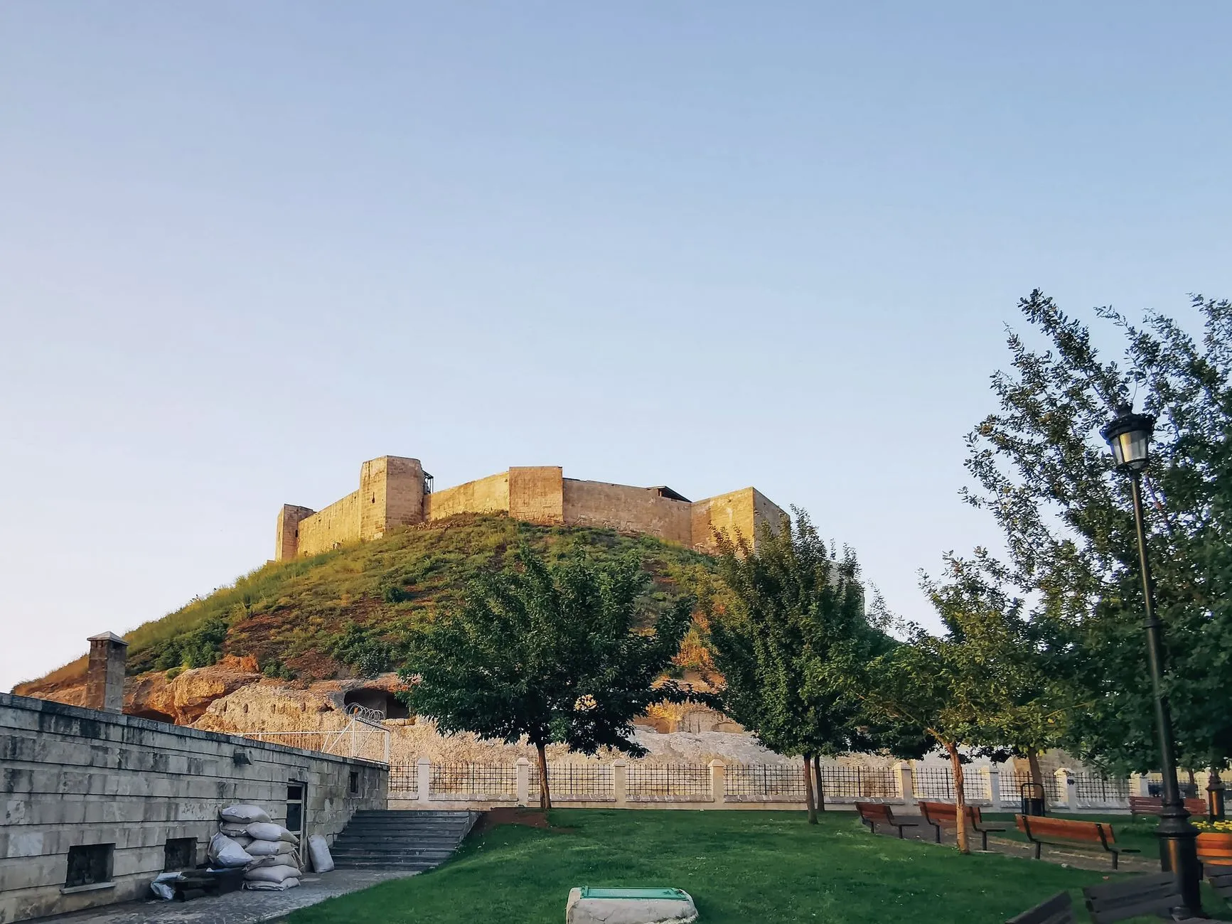 Gaziantep, Türkiye — Historic Gaziantep Castle with lush greenery under a clear sky in Turkey.