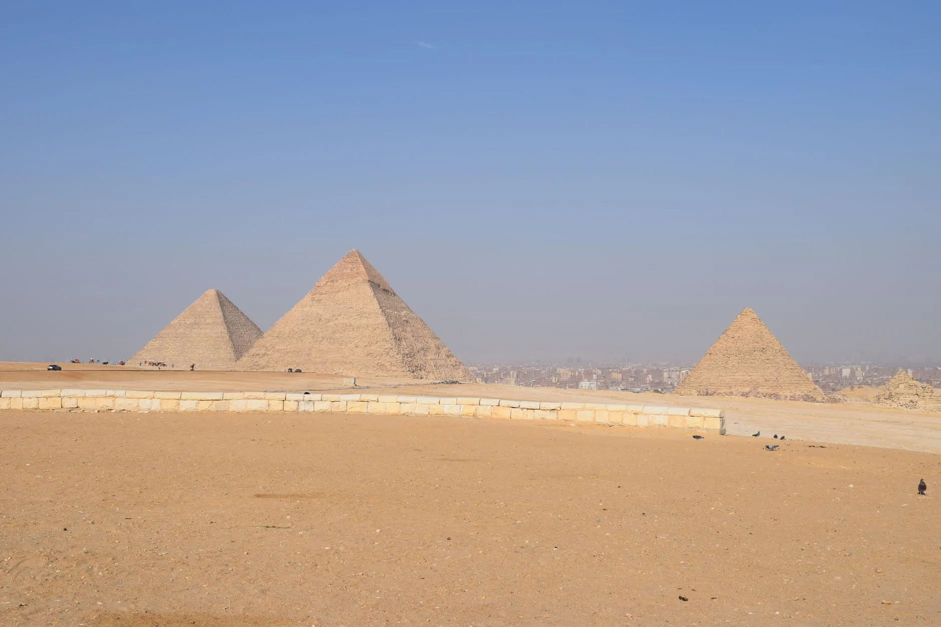 Breathtaking landscape of the Giza Pyramids under a clear blue sky in Cairo, Egypt.