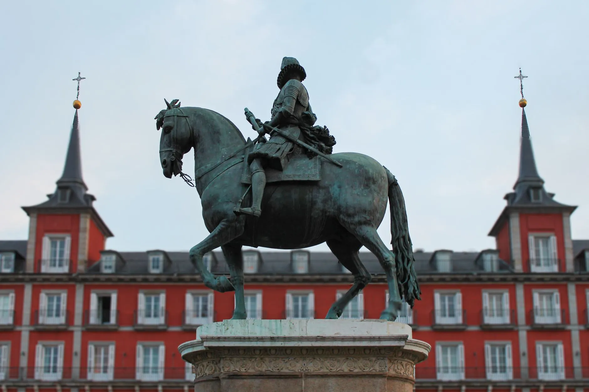 Equestrian statue of King Felipe III at Plaza Mayor during daytime in Madrid, Spain.