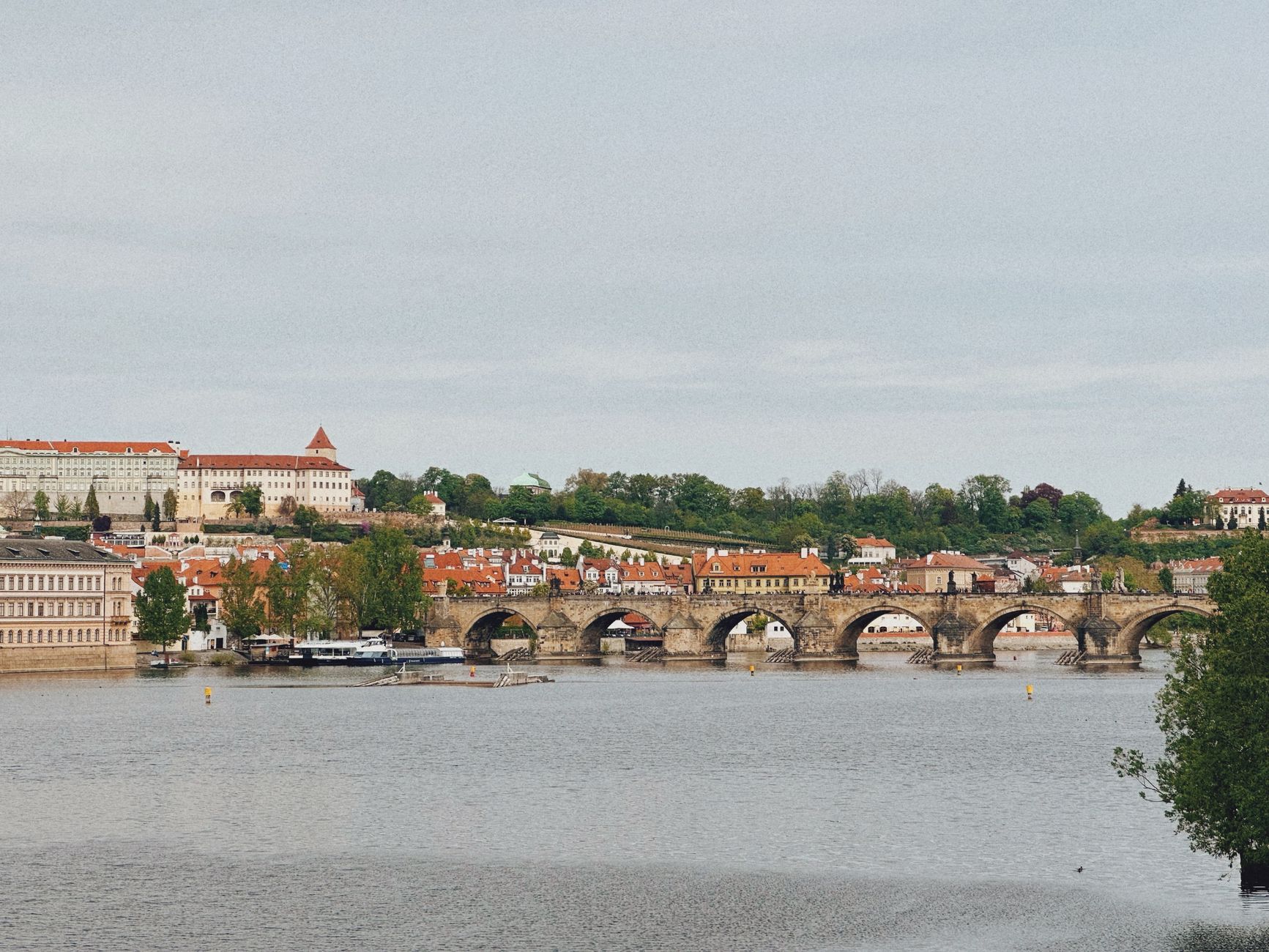 Scenic view of the iconic Charles Bridge spanning the Vltava River in Prague, Czech Republic.