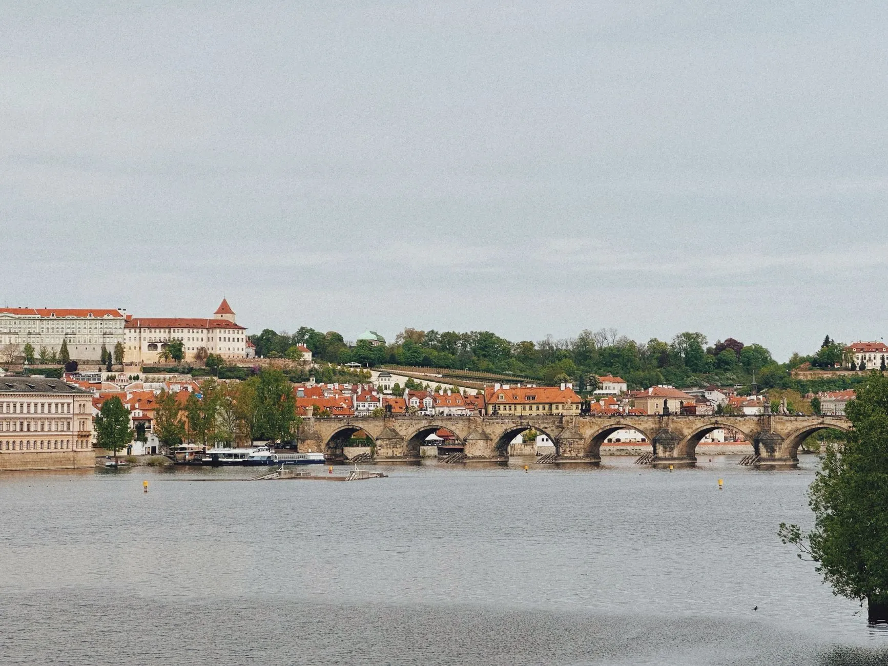 Scenic view of the iconic Charles Bridge spanning the Vltava River in Prague, Czech Republic.