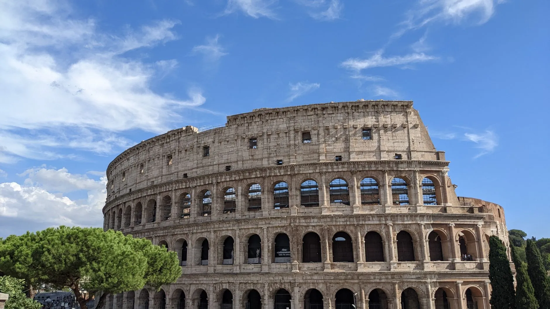 The Colosseum in Rome, Italy stands majestically under a clear blue sky.