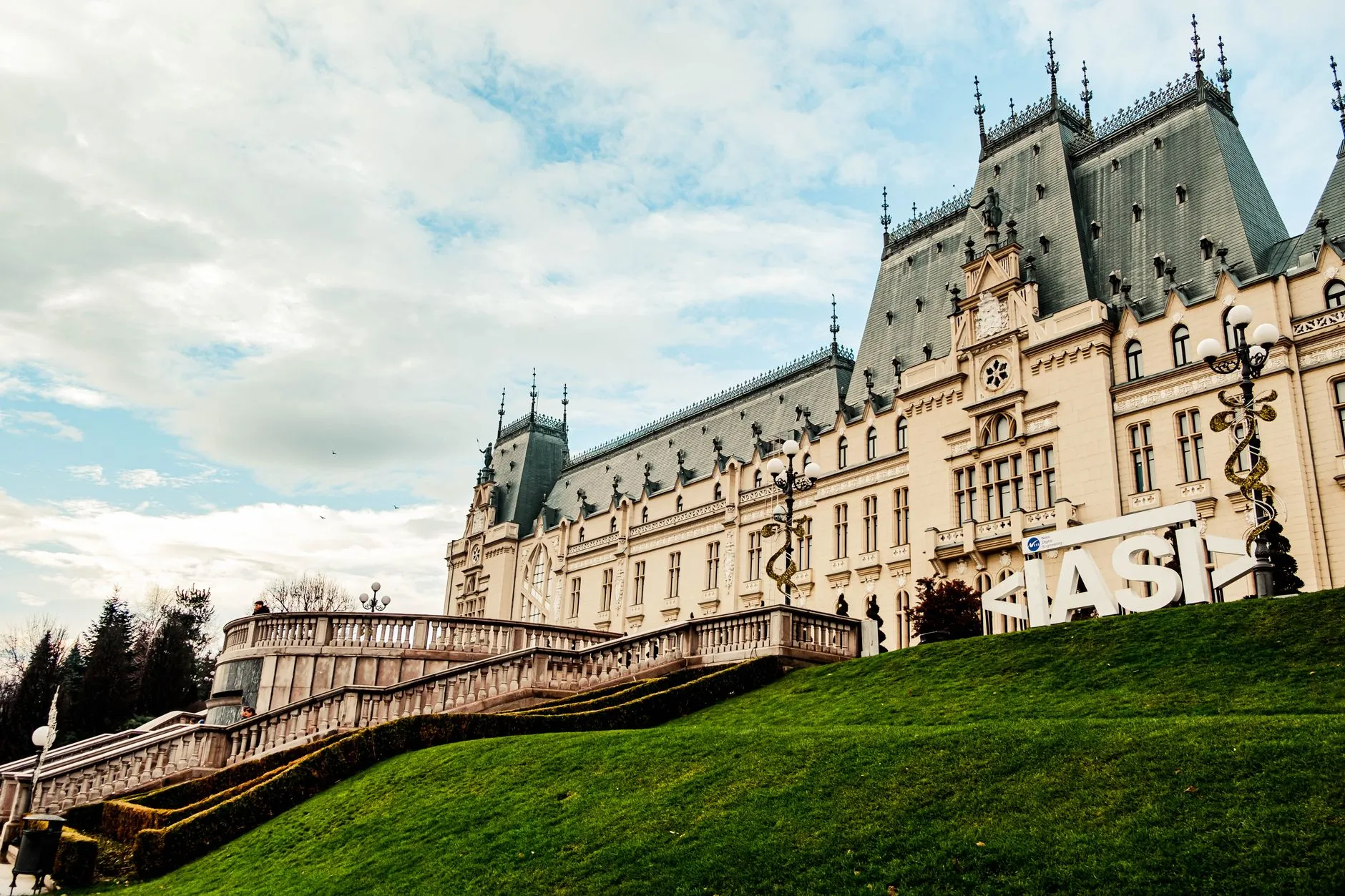 Iaşi, Romania — Majestic Gothic Revival Palace of Culture in Iasi, Romania with green lawns and cloudy skies.