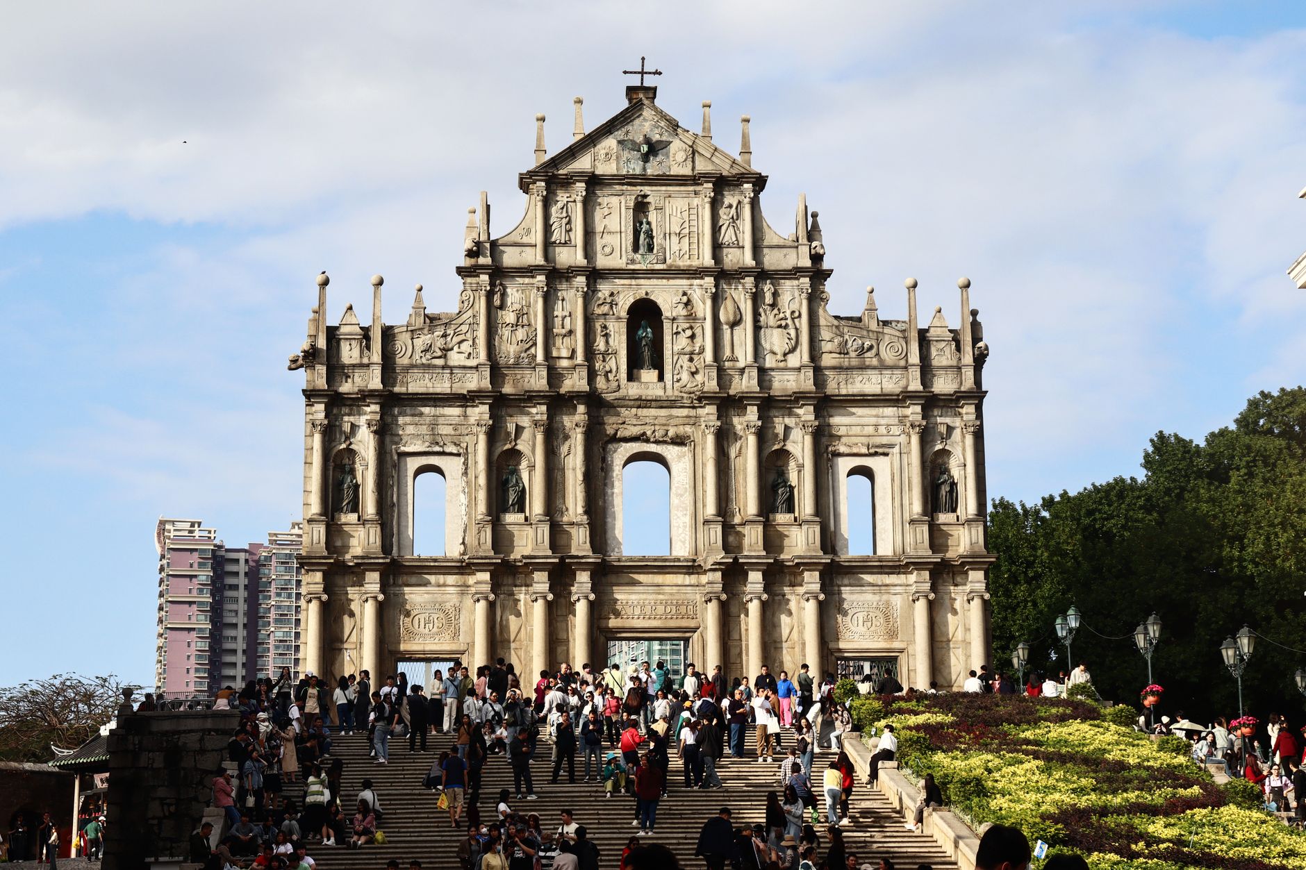 Macau — the stone facade of the Ruins of St. Paul's seen head-on from the steps under a blue sky, Macao SAR, China