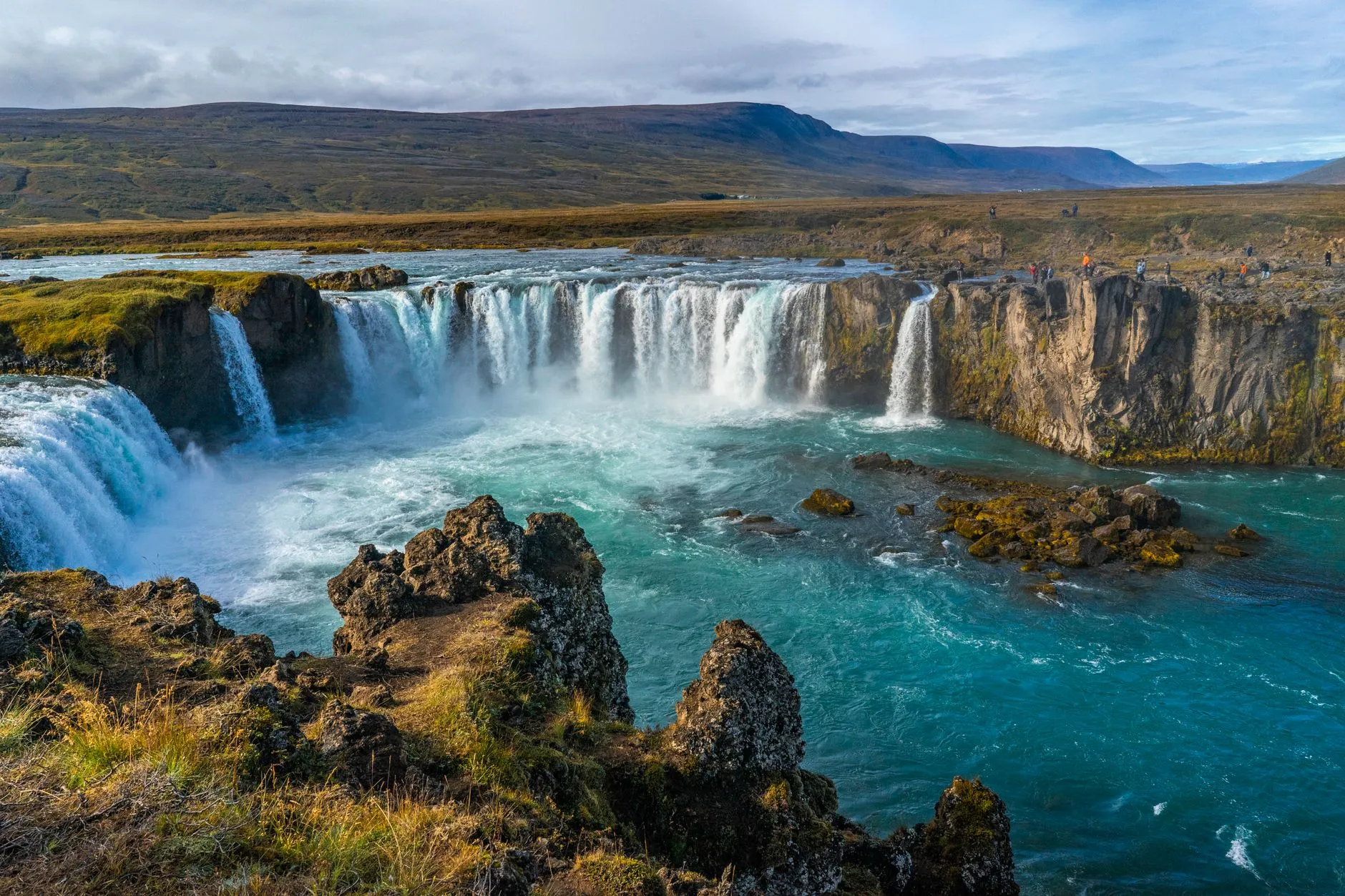 Iceland — godafoss waterfall cascading beautifully amidst rocky terrain, showcasing iceland's breathtaking natural scenery.