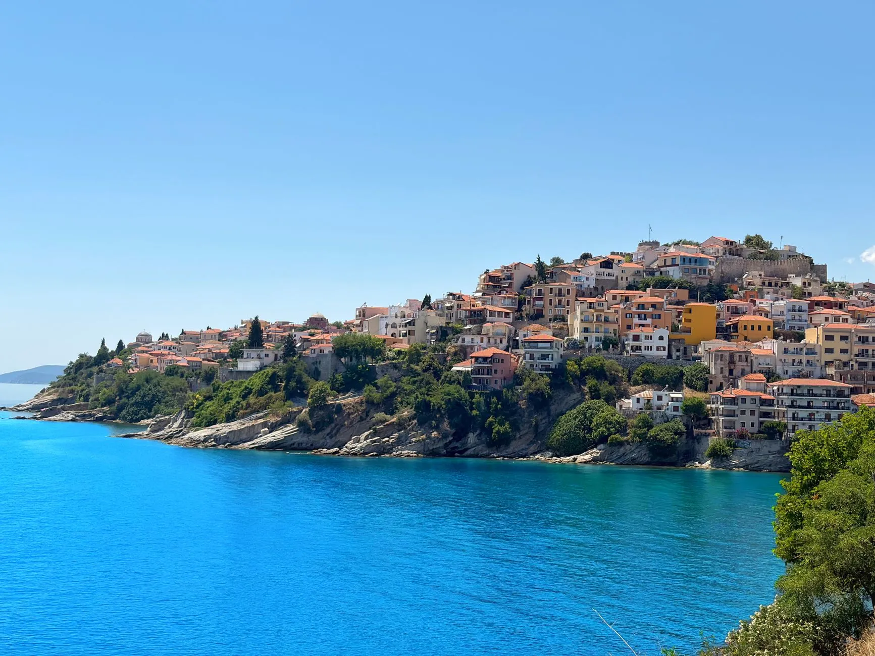 Kavala, Greece — A stunning view of the coastal town of Kavala, Greece, featuring vibrant blue waters and historic architecture.