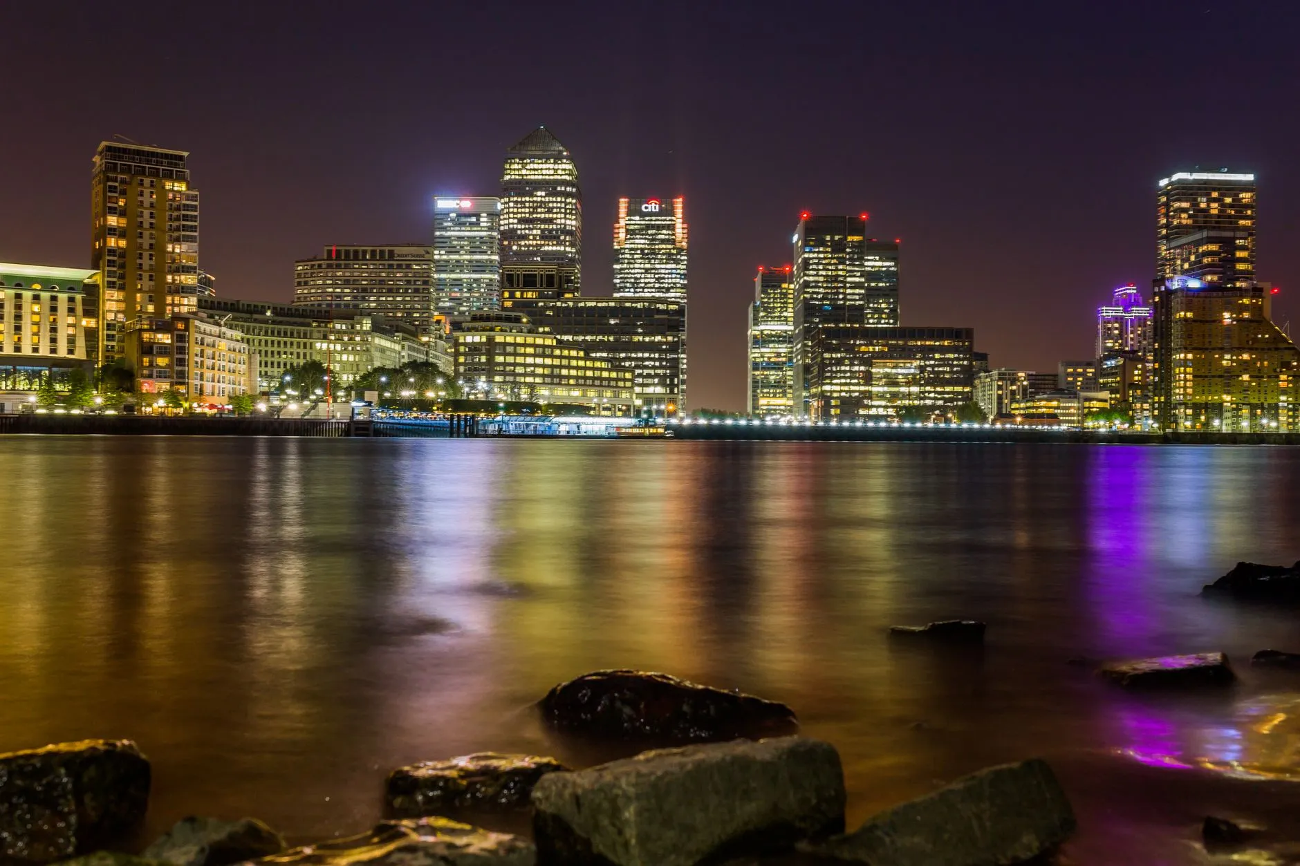 London Docklands — Stunning evening view of London's Canary Wharf skyline reflecting on the Thames.
