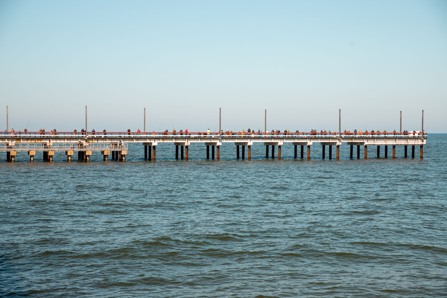 Palanga, Lithuania — View of the bustling Palanga Pier in Lithuania surrounded by the Baltic Sea on a sunny day.