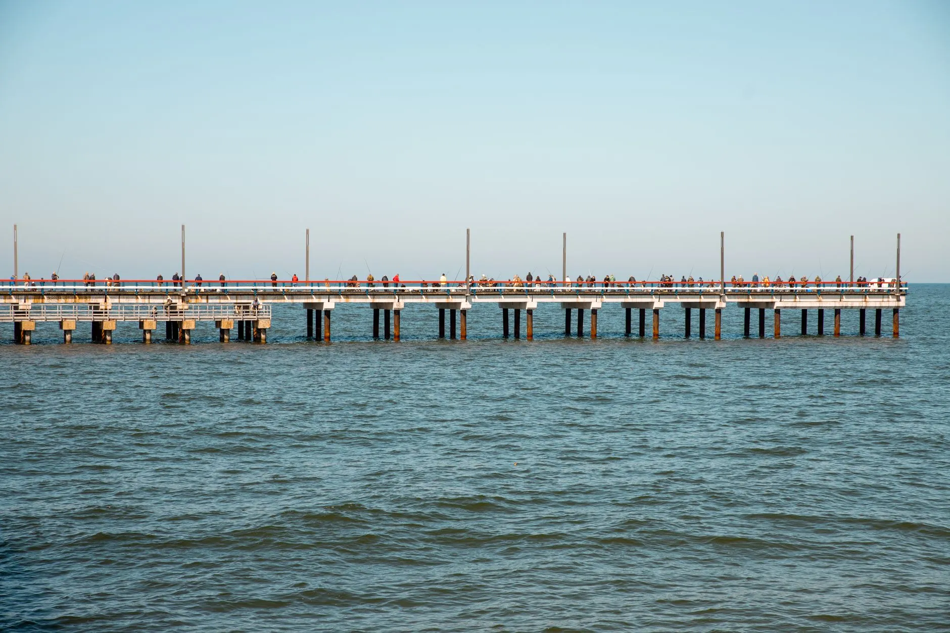 Palanga, Lithuania — View of the bustling Palanga Pier in Lithuania surrounded by the Baltic Sea on a sunny day.