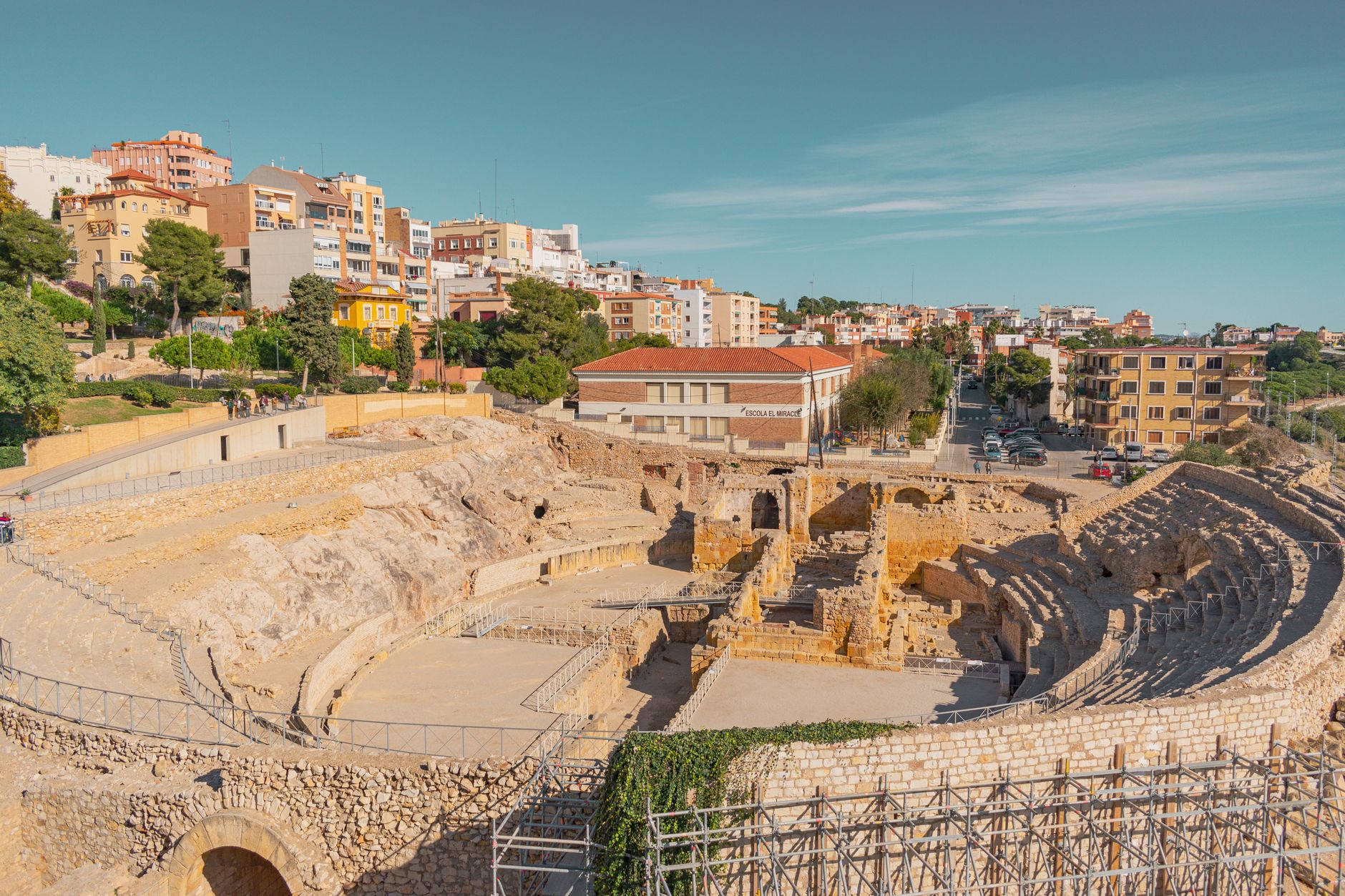Reus, Spain — Discover the ancient Roman Amphitheatre in Tarragona under a clear blue sky.