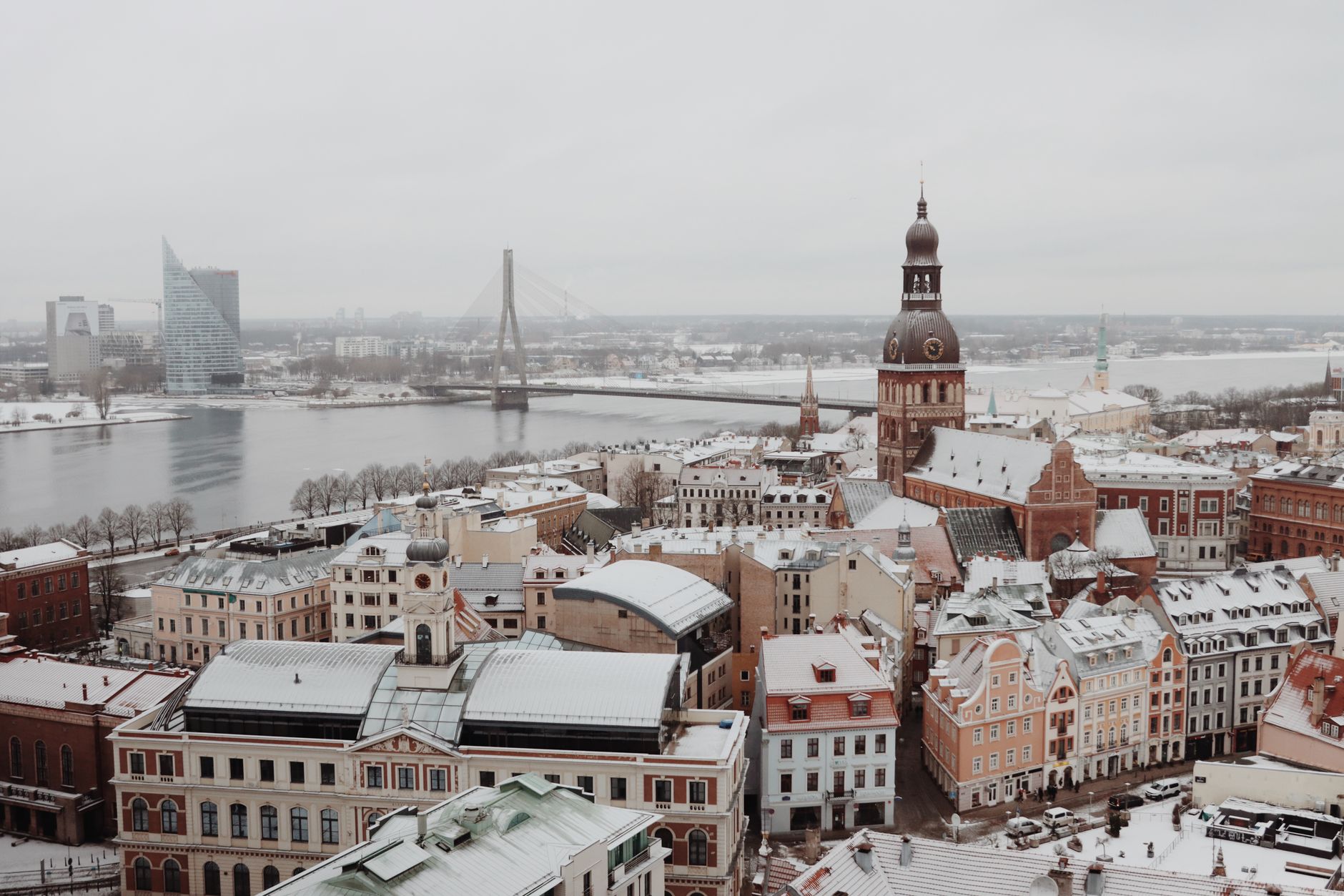 Riga, Latvia — snow on the Old Town rooftops, the cathedral and the Daugava