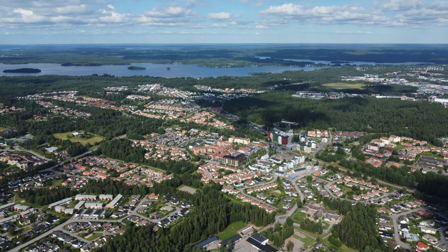 Vaxjo, Sweden — Scenic aerial view of Växjö, Sweden, showing residential areas, lakes, and lush forests on a sunny day.