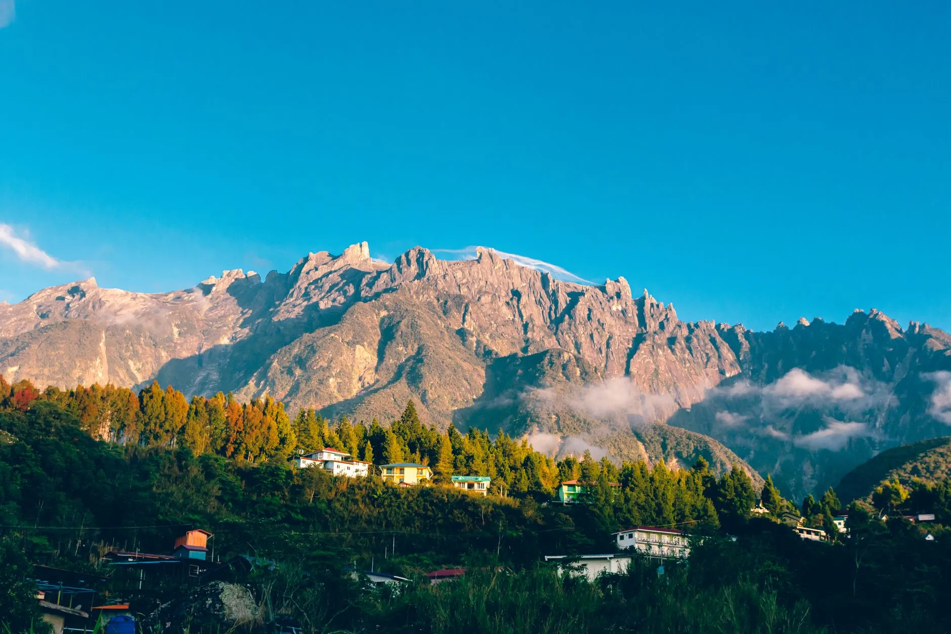Mount Kinabalu's granite peaks above a hillside village, Sabah, Malaysia