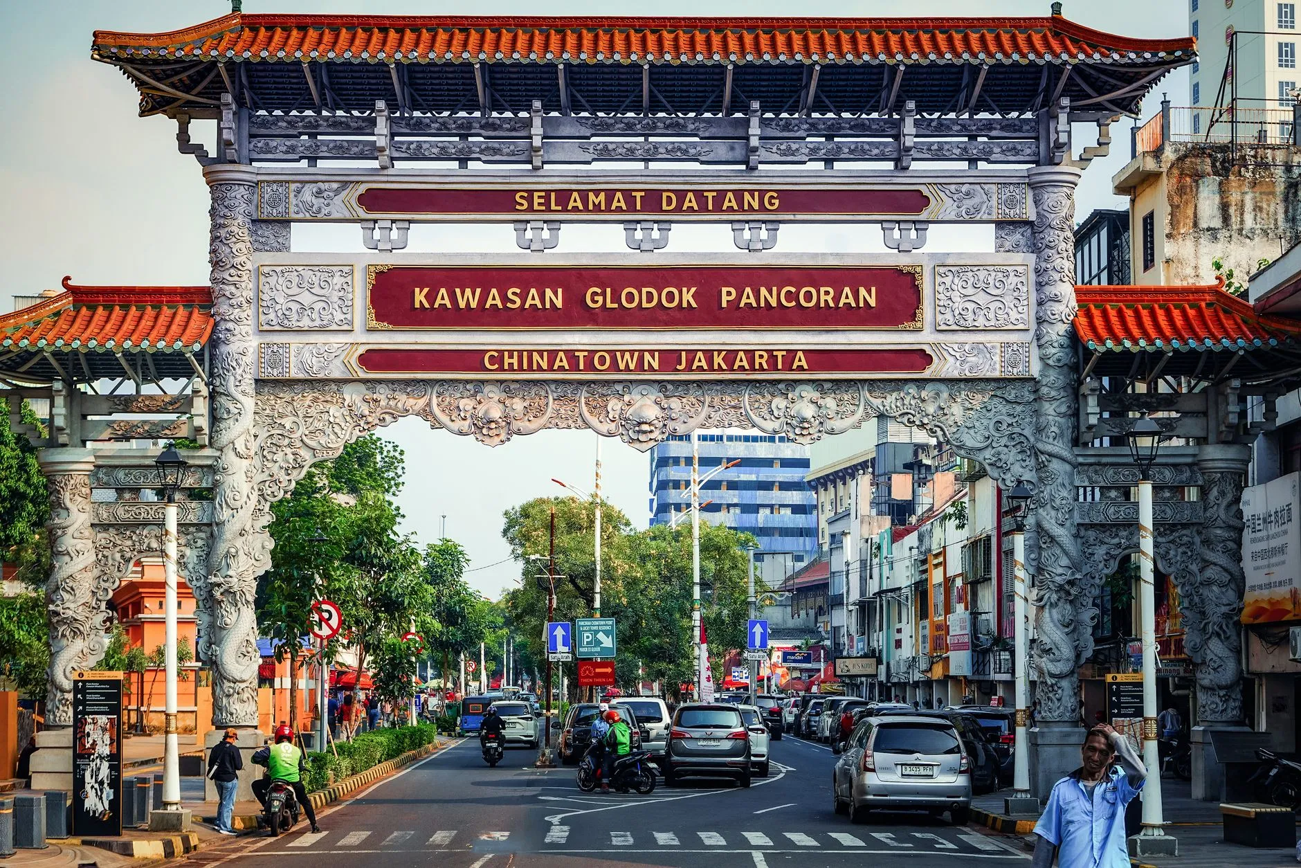 The Chinatown gate at Glodok, Jakarta, with scooters and street life below
