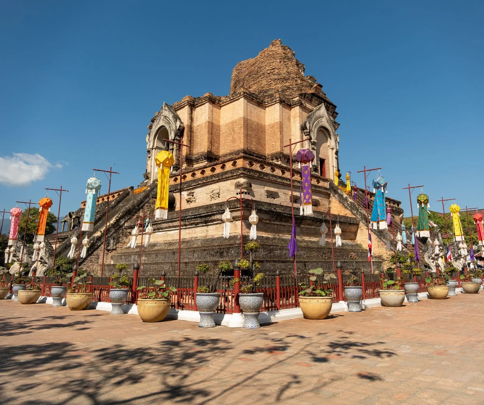 Chiang Mai, Thailand — Wat Chedi Luang's ancient brick chedi hung with Lanna banners