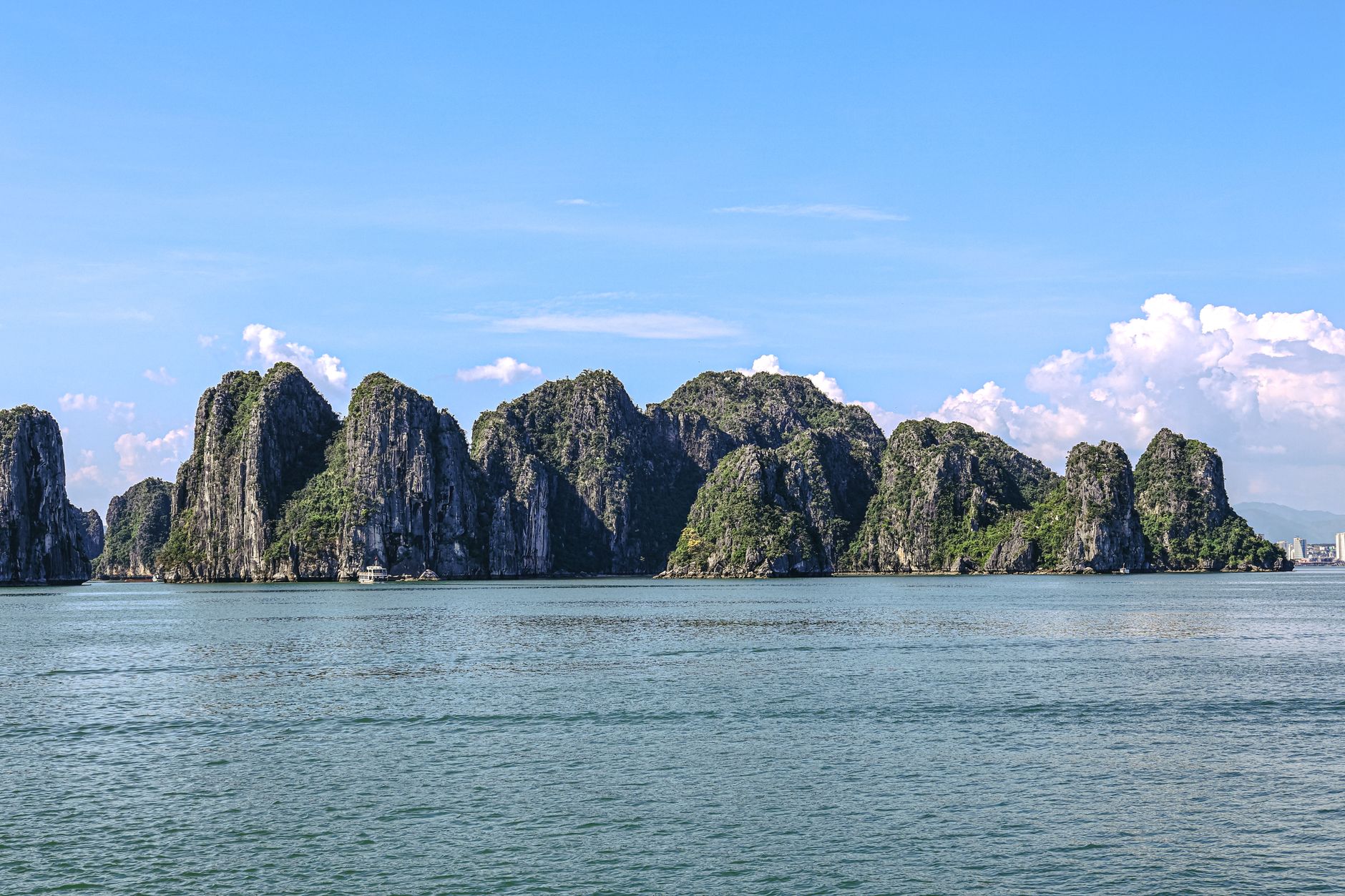 Limestone karsts of Ha Long Bay, Vietnam, under a clear blue sky